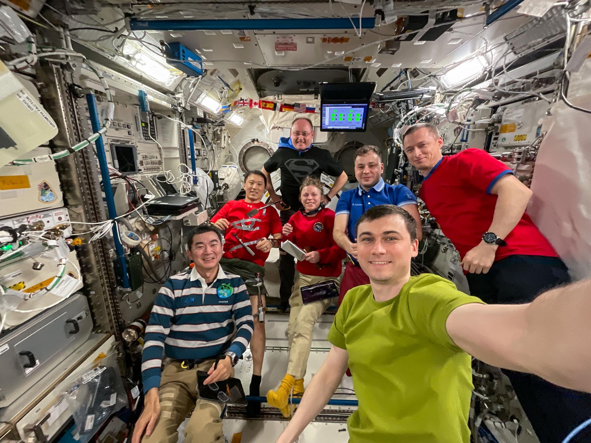 Roscosmos cosmonaut Alexey Zubritsky holds the camera for a group selfie with fellow Expedition 73 crew members Kimiya Yui of JAXA (Japan Aerospace Exploration Agency) at lower left, (second row from left) NASA astronauts Jonny Kim and Zena Cardman, Roscosmos cosmonauts Oleg Platonov and Sergey Ryzhikov, and in the back, NASA astronaut Mike Fincke.