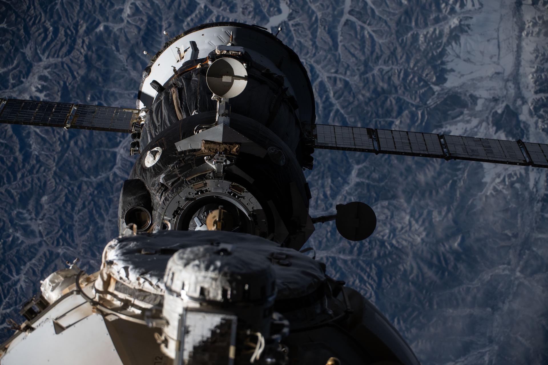 The Soyuz MS-27 spacecraft—carrying NASA astronaut Jonny Kim and Roscosmos cosmonauts Sergey Ryzhikov and Alexey Zubritsky—backs away from the International Space Station moments after undocking from the Poisk module while orbiting 265 miles above the frozen landscape of northwest Asia. The trio parachuted to Earth less than three-and-a-half hours later inside the Soyuz descent module completing a 245-day space research mission aboard the orbital outpost.
