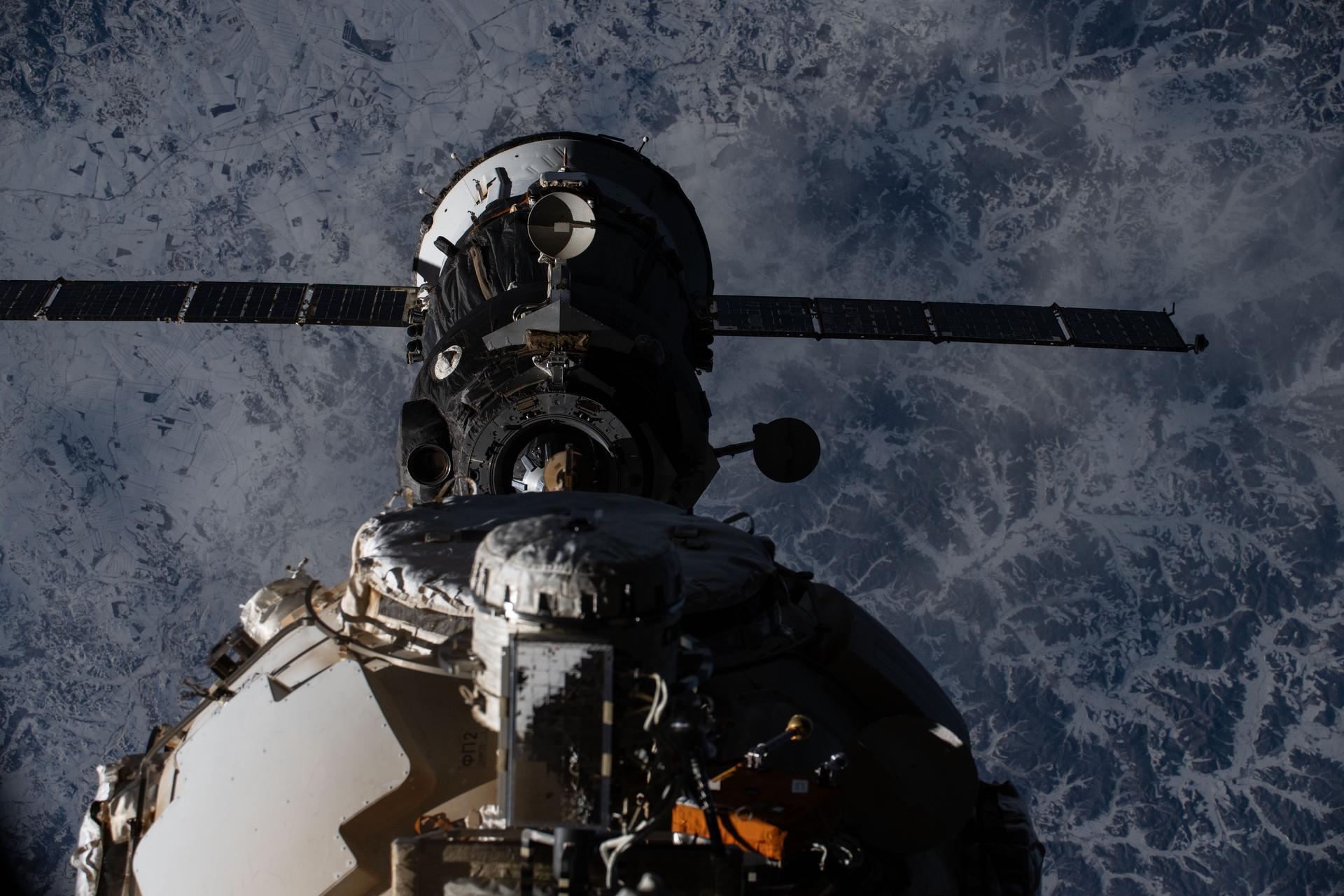 The Soyuz MS-27 spacecraft—carrying NASA astronaut Jonny Kim and Roscosmos cosmonauts Sergey Ryzhikov and Alexey Zubritsky—backs away from the International Space Station moments after undocking from the Poisk module while orbiting 265 miles above the frozen landscape of northwest Asia. The trio parachuted to Earth less than three-and-a-half hours later inside the Soyuz descent module completing a 245-day space research mission aboard the orbital outpost.
