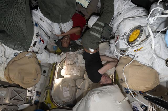 NASA image: NASA astronauts Chris Williams and Zena Cardman work on spacesuit maintenance