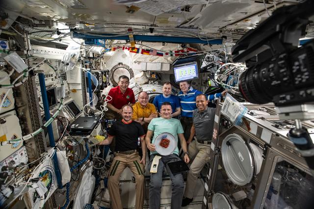 NASA image: The seven-member Expedition 74 crew gathers for a portrait inside the International Space Station