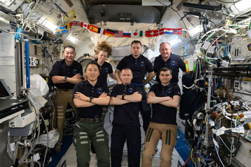 The seven-member Expedition 73 crew gathers for a portrait inside the International Space Station’s Kibo laboratory module. In the front row, from left, are NASA astronaut Jonny Kim and Roscosmos cosmonauts Sergey Ryzhikov and Alexey Zubritsky. In the back row are Kimiya Yui of JAXA (Japan Aerospace Exploration Agency), Zena Cardman of NASA, Oleg Platonov of Roscosmos, and Mike Fincke of NASA.