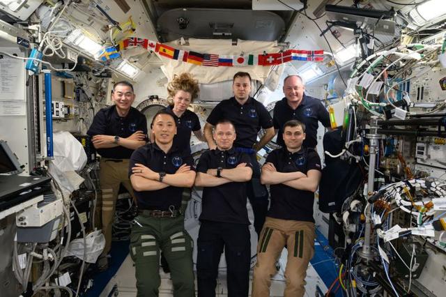 iss074e0006146 (Dec. 8, 2025) --- The seven-member Expedition 73 crew gathers for a portrait inside the International Space Station’s Kibo laboratory module. In the front row, from left, are NASA astronaut Jonny Kim and Roscosmos cosmonauts Sergey Ryzhikov and Alexey Zubritsky. In the back row are Kimiya Yui of JAXA (Japan Aerospace Exploration Agency), Zena Cardman of NASA, Oleg Platonov of Roscosmos, and Mike Fincke of NASA.