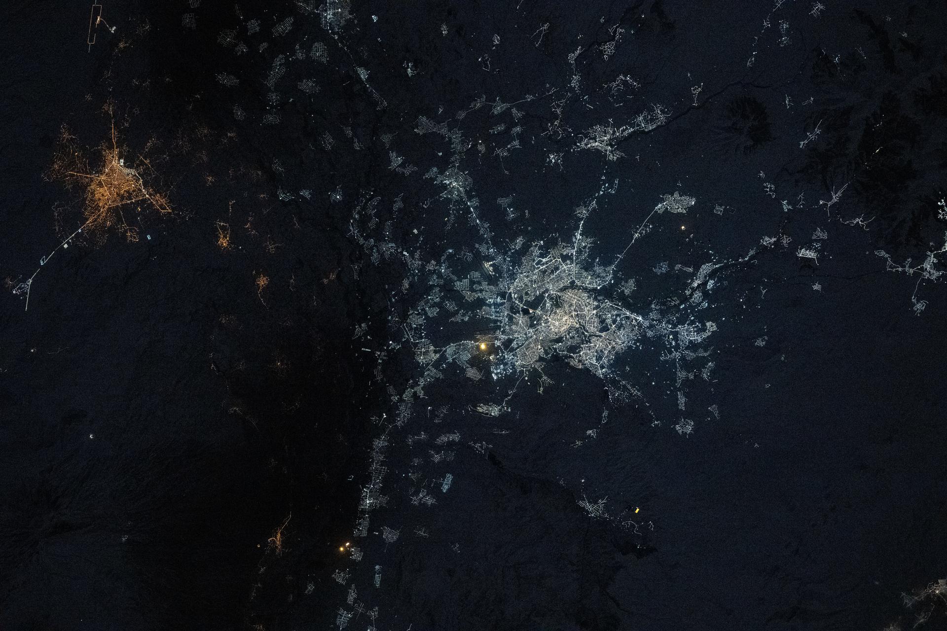 Yerevan, Armenia, and its modernized bright LED city lights contrast with the older amber high-pressure sodium lights of Iğdır, Türkiye (left), in this photograph from the International Space Station as it orbited 262 miles above Earth at approximately 11:12 p.m. local time.