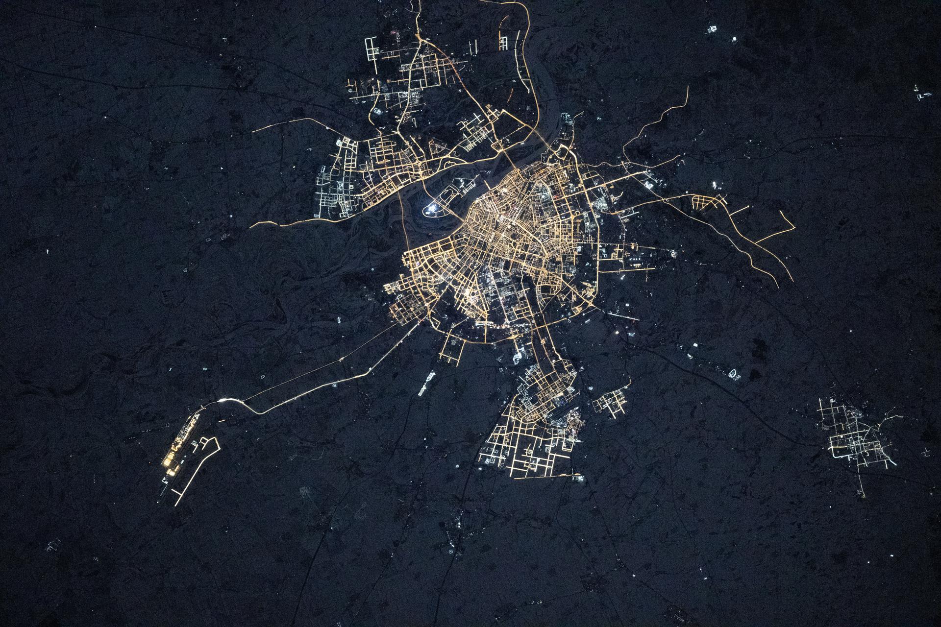 Harbin, China—nicknamed the “Ice City” for its long, harsh winters and home to about 10.6 million people—is pictured at approximately 3:28 a.m. local time from the International Space Station as it orbited 266 miles above the Asian continent. The city hosts the world-famous Harbin International Ice and Snow Festival and serves as an economic hub for manufacturing, energy, and education.