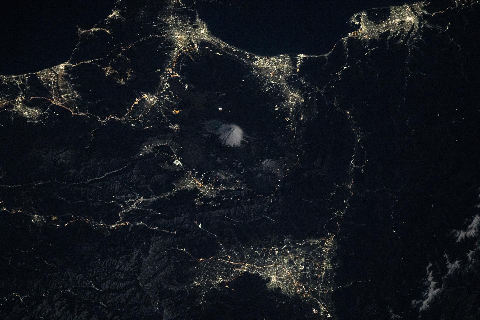 Mount Fuji, Japan’s tallest mountain and an active volcano, is surrounded by the city lights of the Fuji Five Lakes region and the Yamanashi and Shizuoka prefectures, home to more than 5 million people. The International Space Station captured this view from 265 miles above the Sea of Japan at approximately 4:31 a.m. local time.