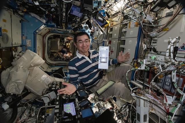 NASA image: JAXA astronaut Kimiya Yui displays an advanced sample processing cassette