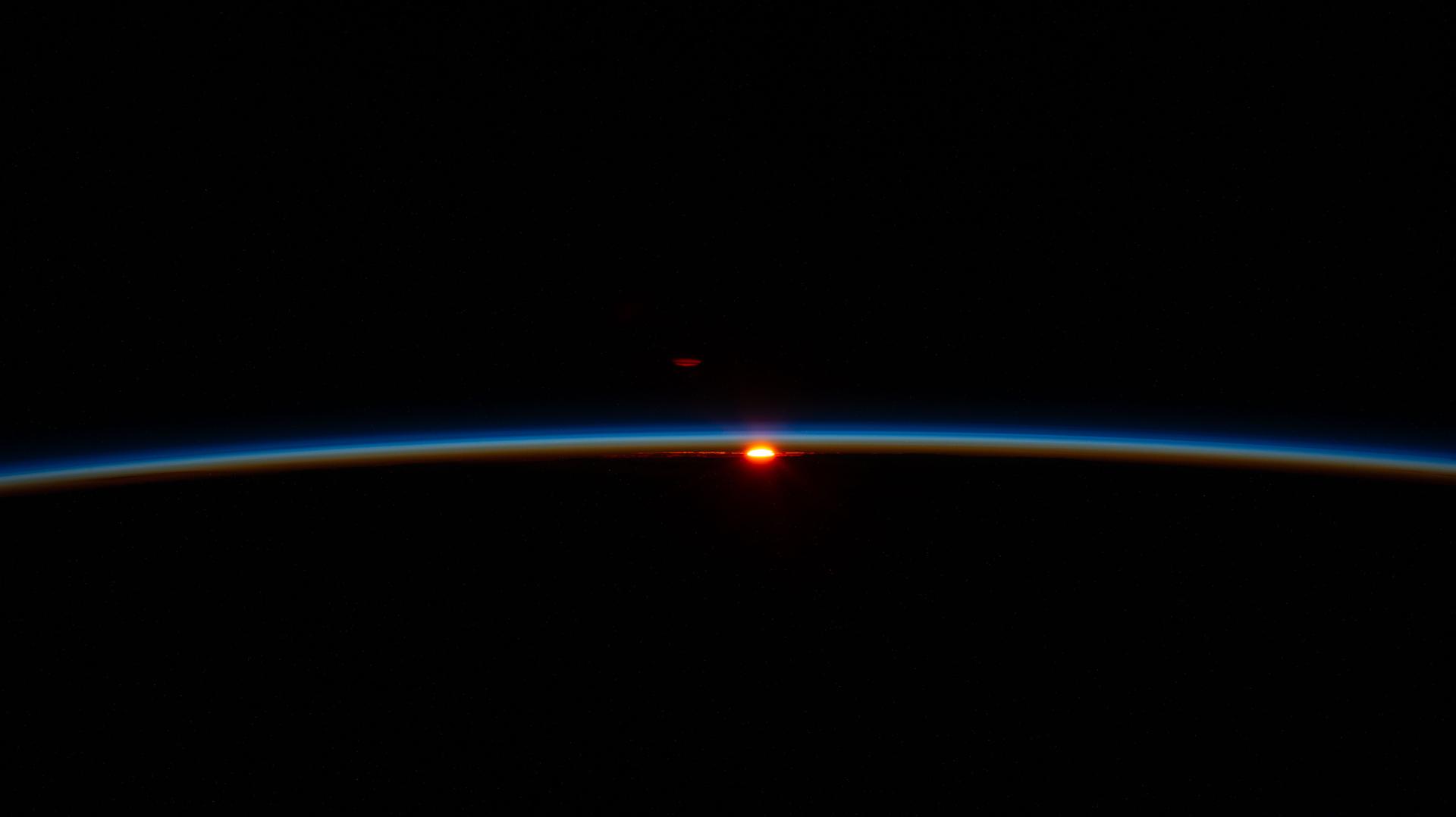 The first rays of an orbital sunrise illuminate Earth’s atmosphere in this photograph taken from the International Space Station as it orbited 268 miles above French Polynesia in the Pacific Ocean at approximately 2:52 a.m. local time.