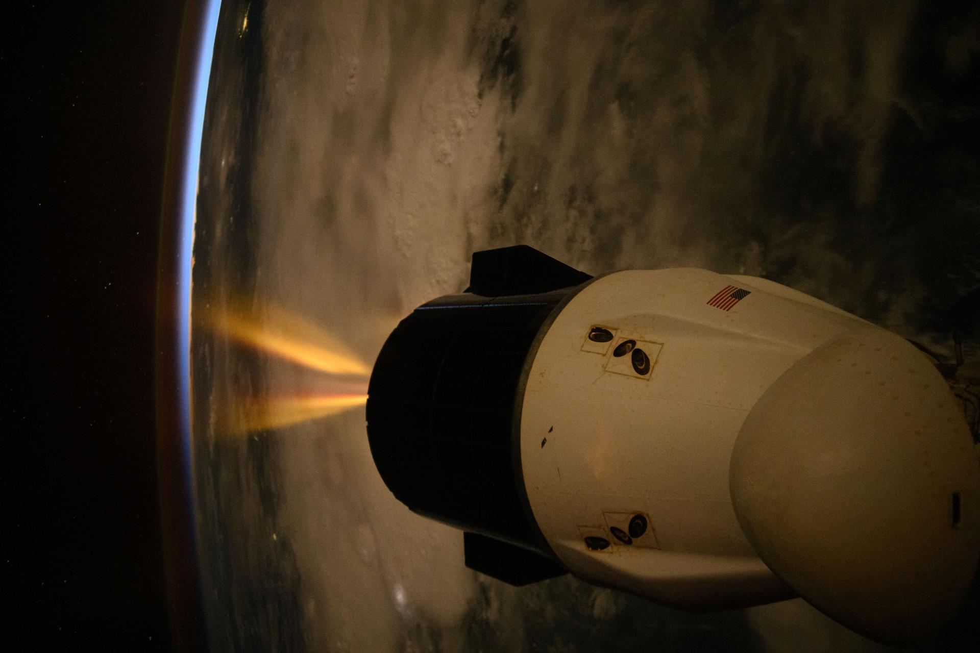 A SpaceX Dragon spacecraft fires its Draco engines, an independent propellant system located in the spacecraft’s trunk, for a regularly scheduled orbital reboost of the International Space Station. The orbital outpost was soaring into a sunset 259 miles above the Indian Ocean off the coast of Tanzania on the African continent at approximately 9:09 p.m. local time.