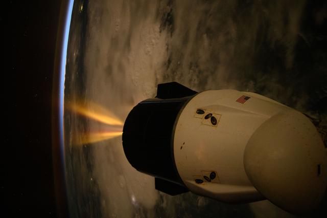 NASA image: A SpaceX Dragon spacecraft fires its Draco engines