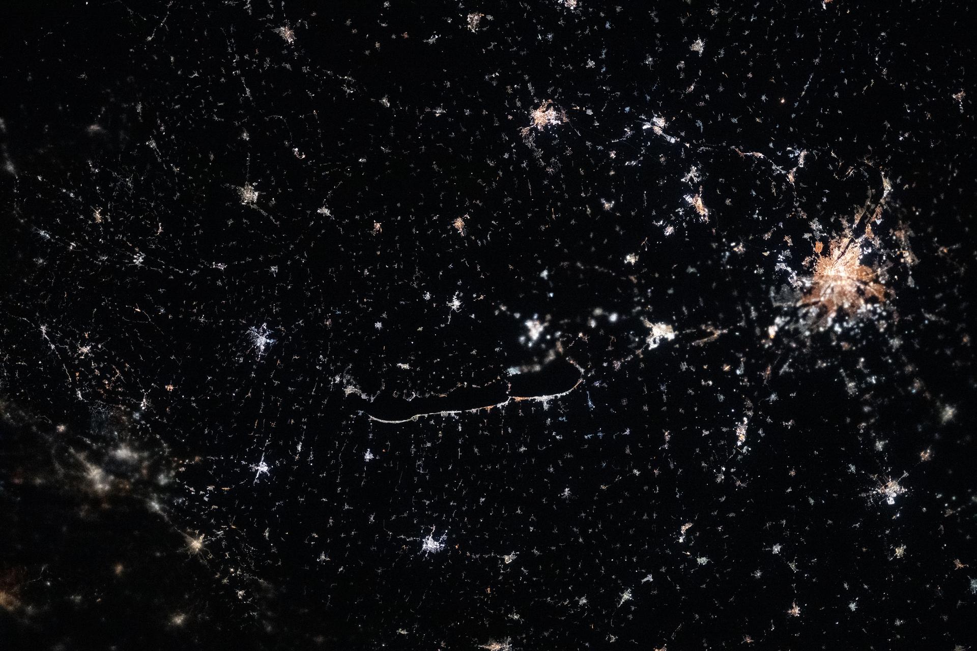 The city lights of Budapest (right) dominate the nightscape of Hungary, which is dotted with small, picturesque villages. At the center of the frame, lies Lake Balaton—Central Europe’s largest lake—surrounded by volcanic hills, vineyards, historic churches, and traditional settlements. The International Space Station was orbiting 262 miles above the region at approximately 9:10 p.m. local time when this photograph was taken.