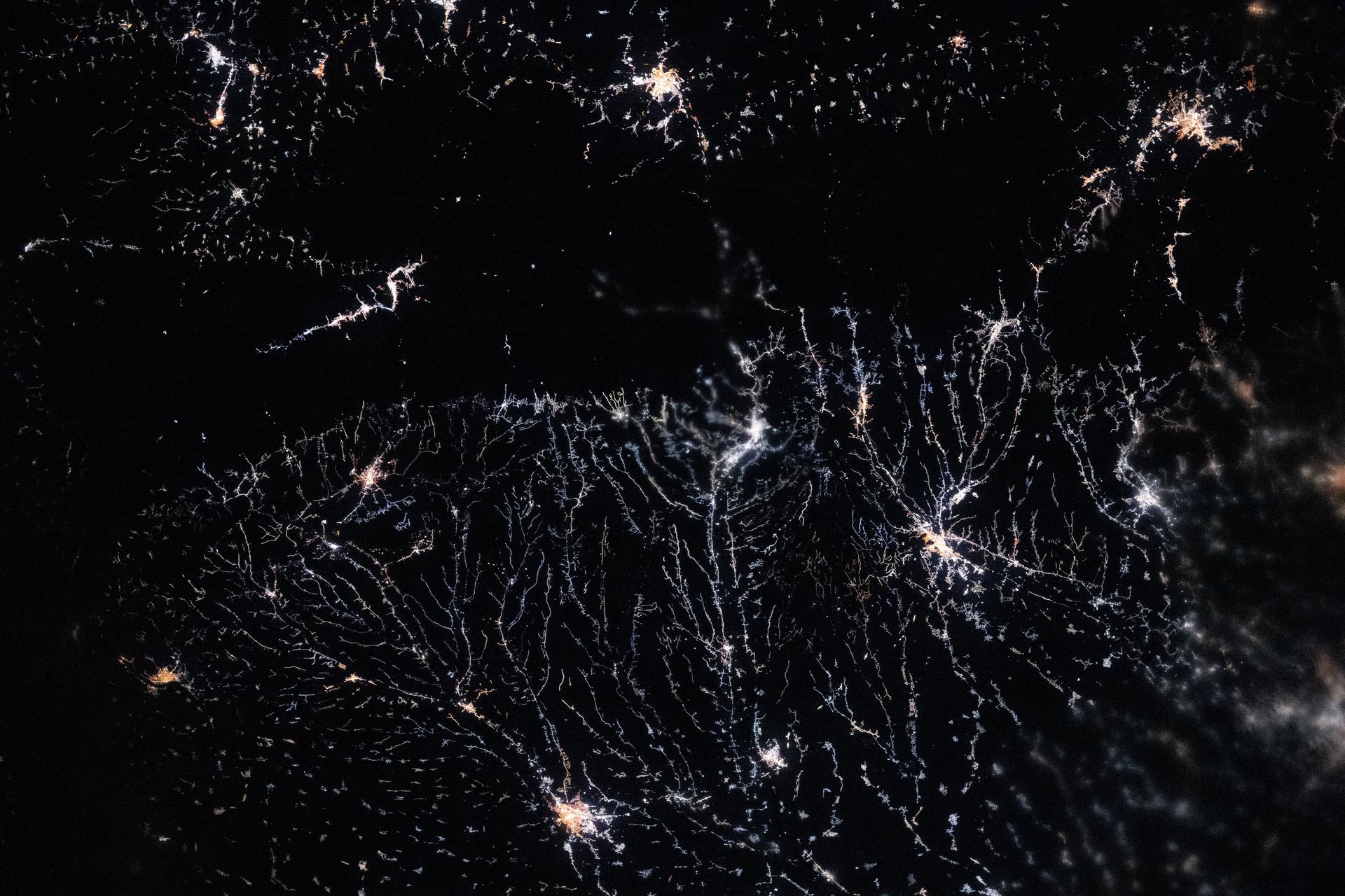 City lights trace river valleys that originate in the Carpathian Mountains and drain into the fertile lowlands of the Wallachian Plain in Romania. The International Space Station was orbiting 262 miles above Europe at 10:11 p.m. local time when this photograph was taken.