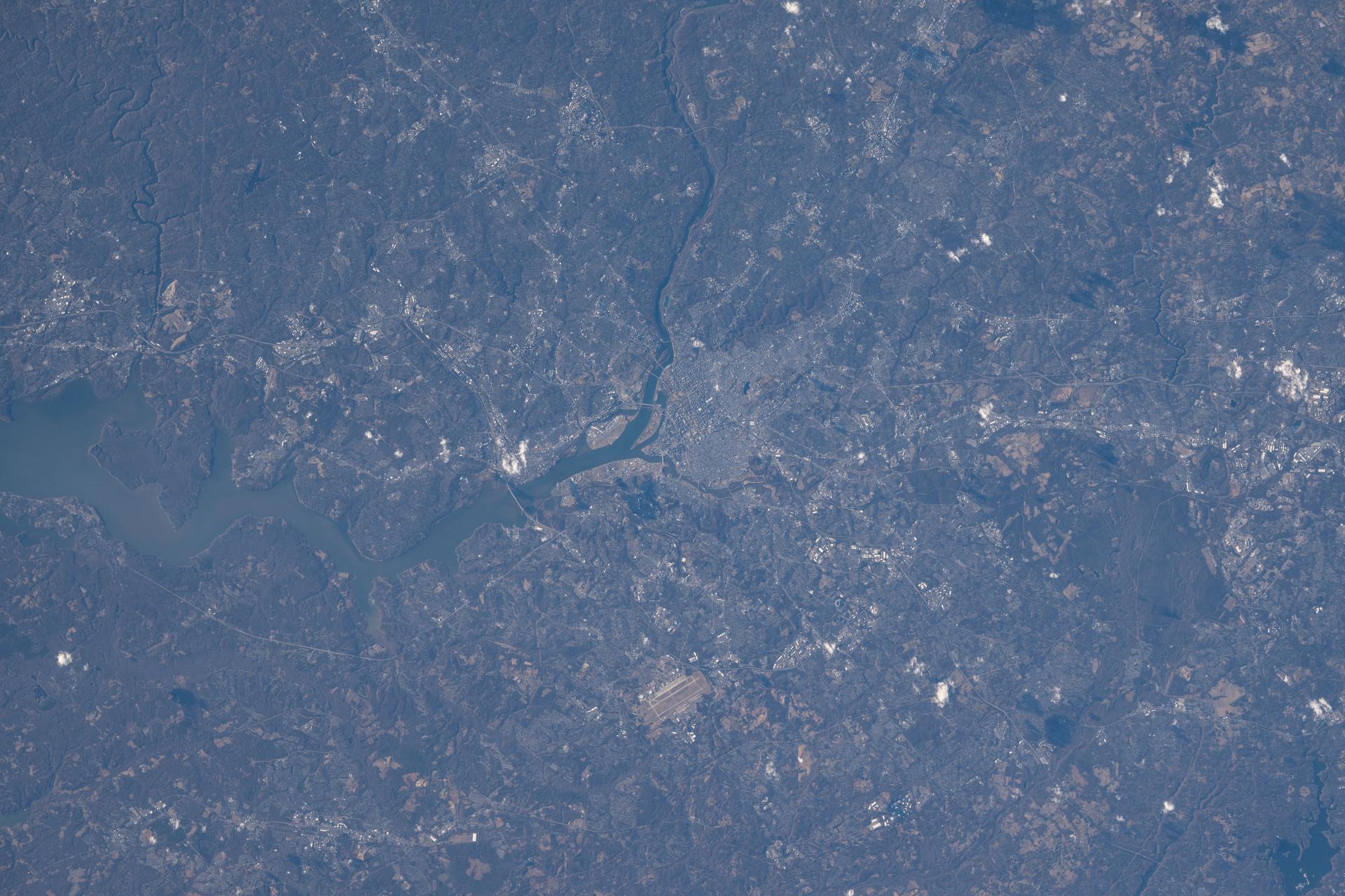 Washington, D.C., located across the Potomac River from Arlington, Virginia, is the capital of the United States and home to over 700,000 residents. The metropolitan area, which includes portions of Maryland, Virginia, and West Virginia, has approximately 6.3 million residents. The International Space Station was orbiting 259 miles above Earth when this photograph was taken.