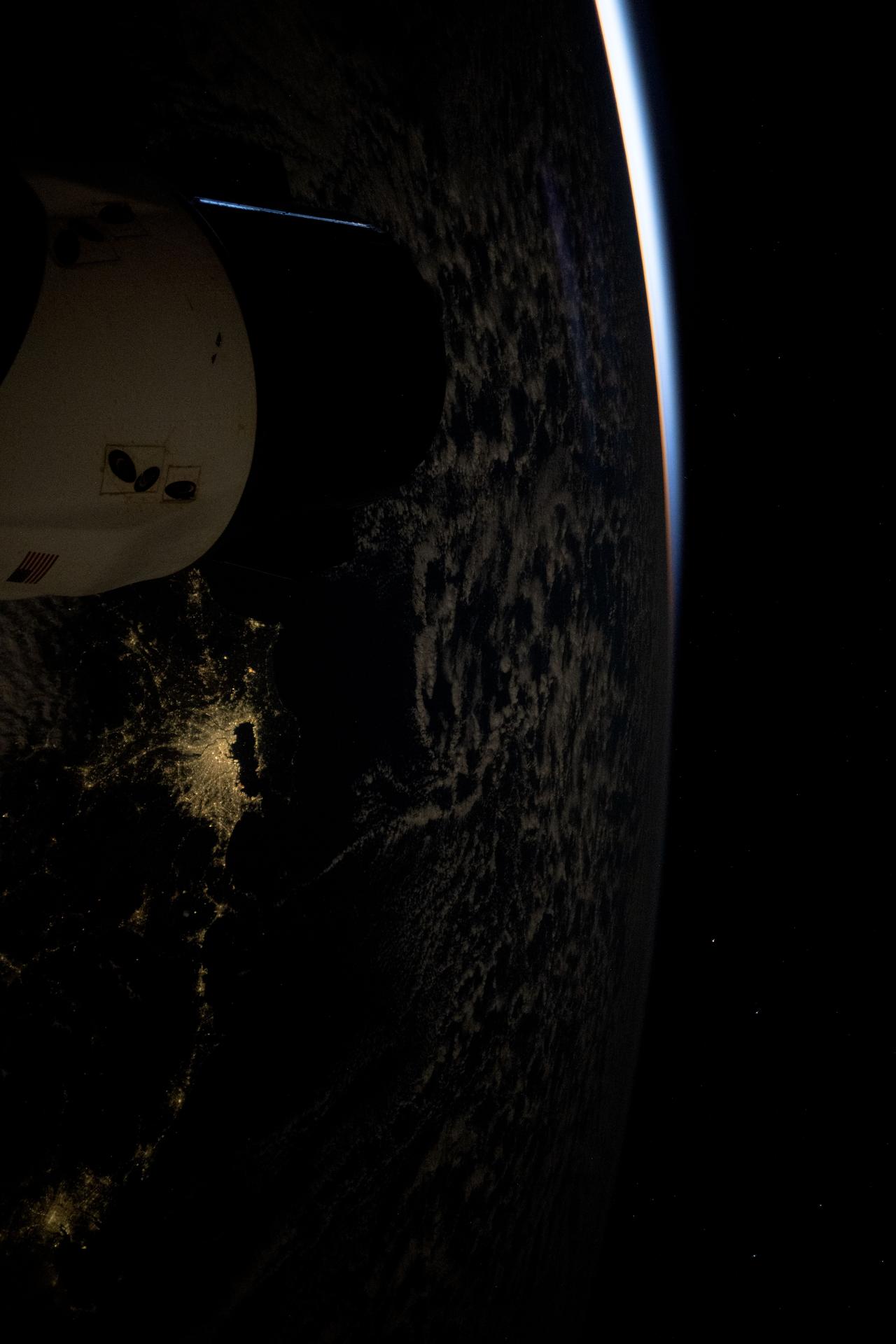 The Greater Tokyo Area in Japan, one of the most populous metropolitan areas on Earth with about 37 million residents, is pictured at approximately 4:31 a.m. local time from the International Space Station. A partially obscured SpaceX Dragon spacecraft (left) is docked to the Harmony module's forward port as both spacecraft soared 265 miles above Earth into an orbital sunrise.