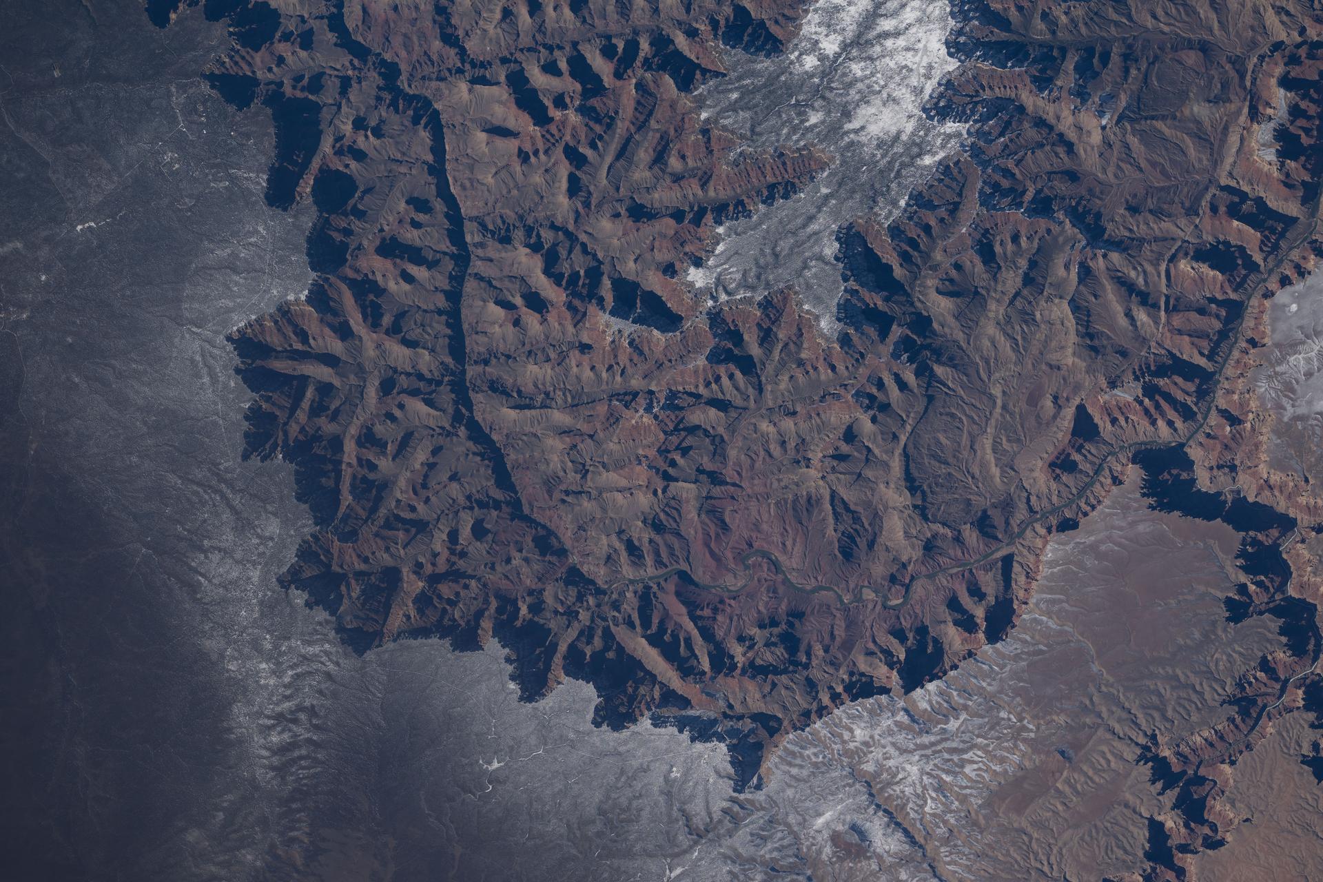 The Colorado River began carving the Grand Canyon—one of the Seven Natural Wonders of the World and a UNESCO World Heritage Site in Arizona—about 5 to 6 million years ago. This photograph was taken from the International Space Station as it orbited 260 miles above the Colorado Plateau in the southwestern United States.
