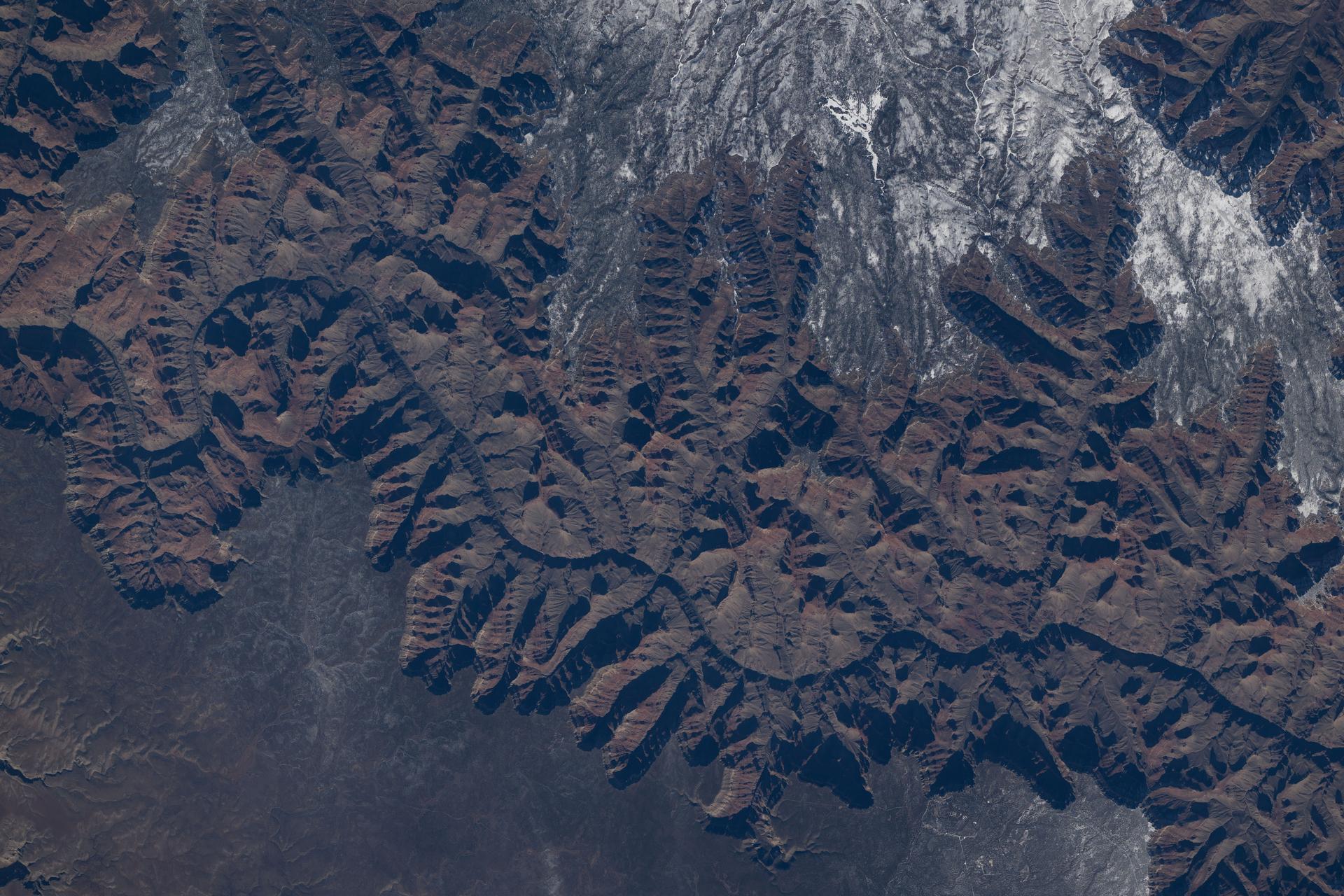 The Colorado River began carving the Grand Canyon—one of the Seven Natural Wonders of the World and a UNESCO World Heritage Site in Arizona—about 5 to 6 million years ago. This photograph was taken from the International Space Station as it orbited 260 miles above the Colorado Plateau in the southwestern United States.