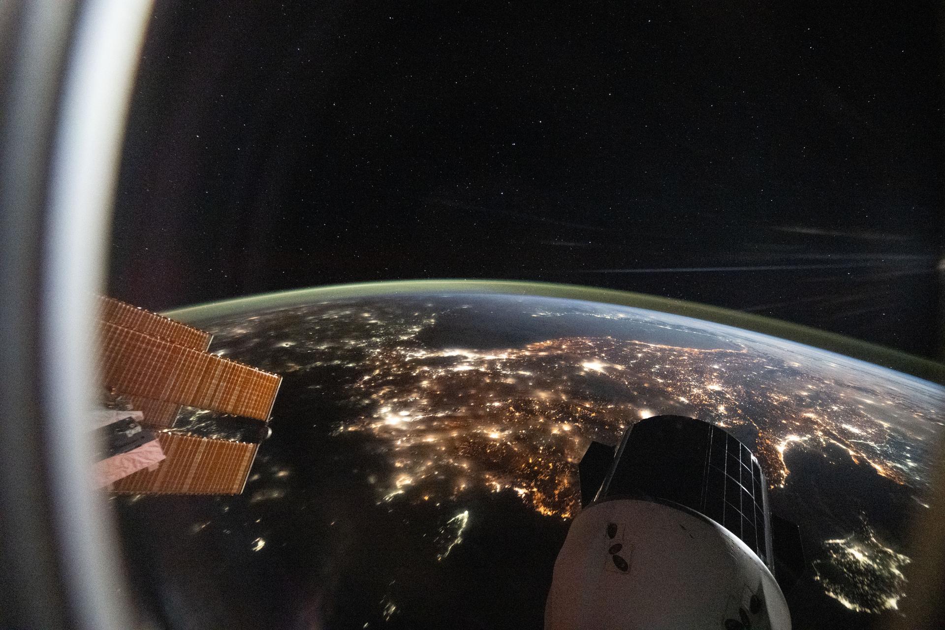 The city lights of Türkiye sparkle 261 miles below the International Space Station in this photograph from a window aboard a SpaceX Dragon spacecraft taken at approximately 9:24 p.m. local time. In the foreground, is a set of the orbital outpost's main solar arrays (left) and another SpaceX Dragon spacecraft (lower right).