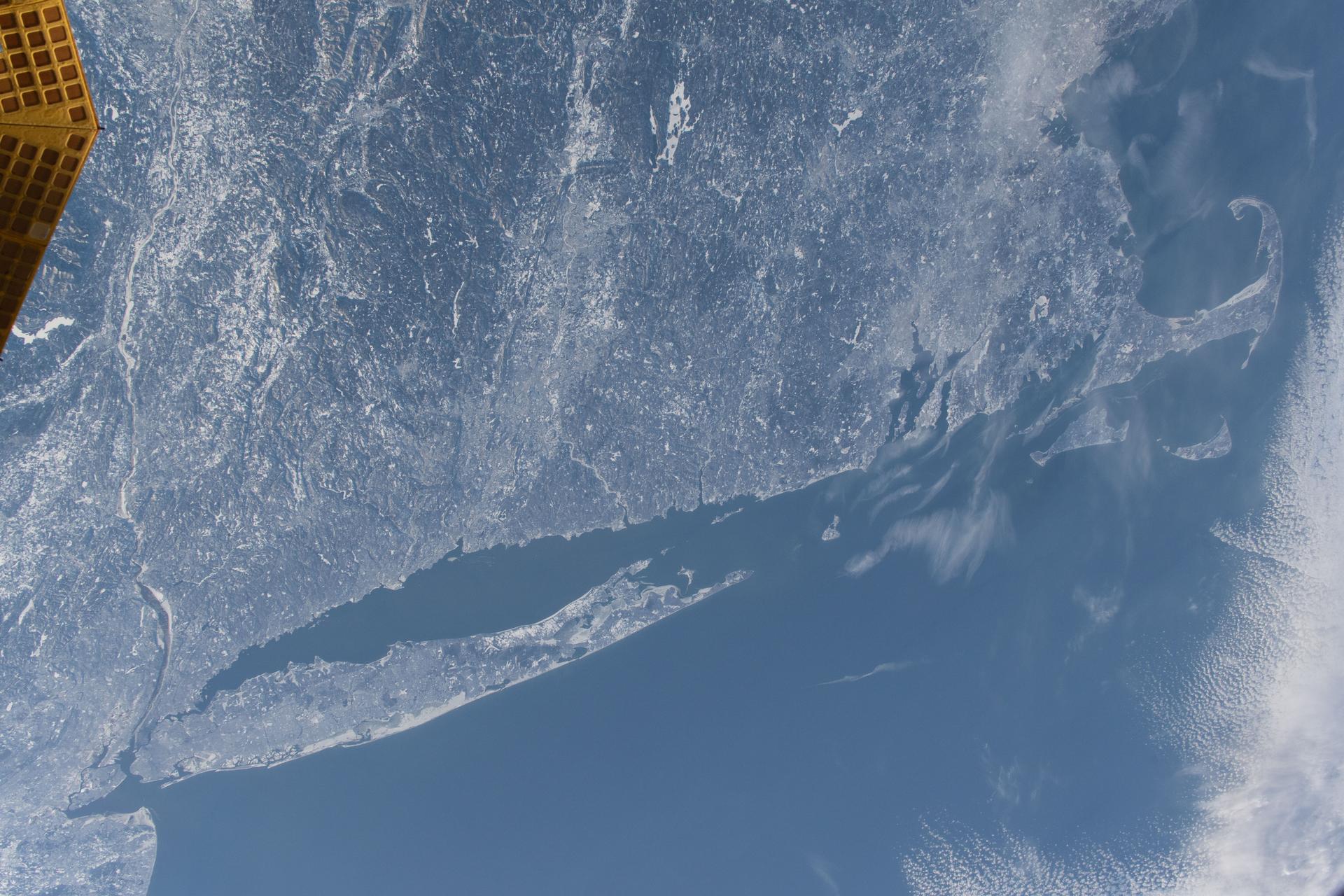 The wintry landscape from New Jersey to Massachussetts is seen from the International Space Station as it orbited 262 miles above the northeastern United States. Temperatures in New York City (lower left) ranged from a low of about 18 degrees Fahrenheit to a high of around 30 degrees when this photograph was taken.
