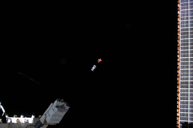 NASA image: A pair of CubeSats is deployed into Earth orbit outside of the International Space Station