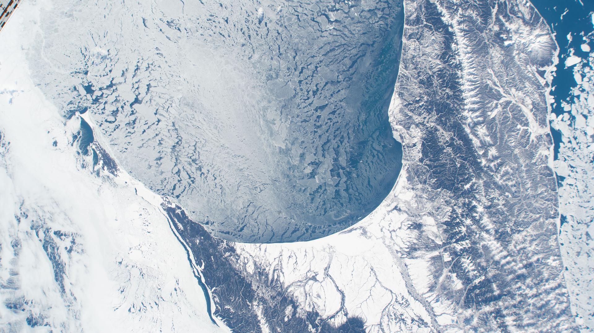 iss074e0312749 (Feb. 10, 2026) --- An icy Zaliv Terpeniya, translated as the Gulf of Patience, on the frozen southeastern coast of Russia’s Sakhalin Island is pictured from the International Space Station as it orbited 261 miles above the Sea of Okhotsk. Credit: NASA