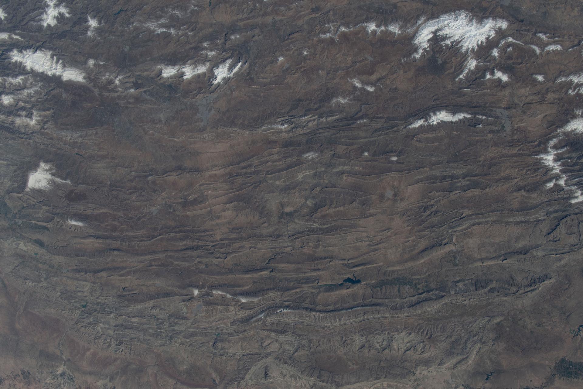 iss074e0315889 (Feb. 16, 2026) --- A portion of the rugged Zagros Mountain range, featuring narrow valleys and rocky outcrops in the semi-arid region of western Iran, is pictured from the International Space Station as it orbited 259 miles above Earth. Credit: NASA/Chris Williams