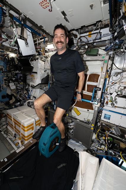 NASA image: NASA astronaut Jack Hathaway smiles for a portrait while pedaling on the exercise cycle