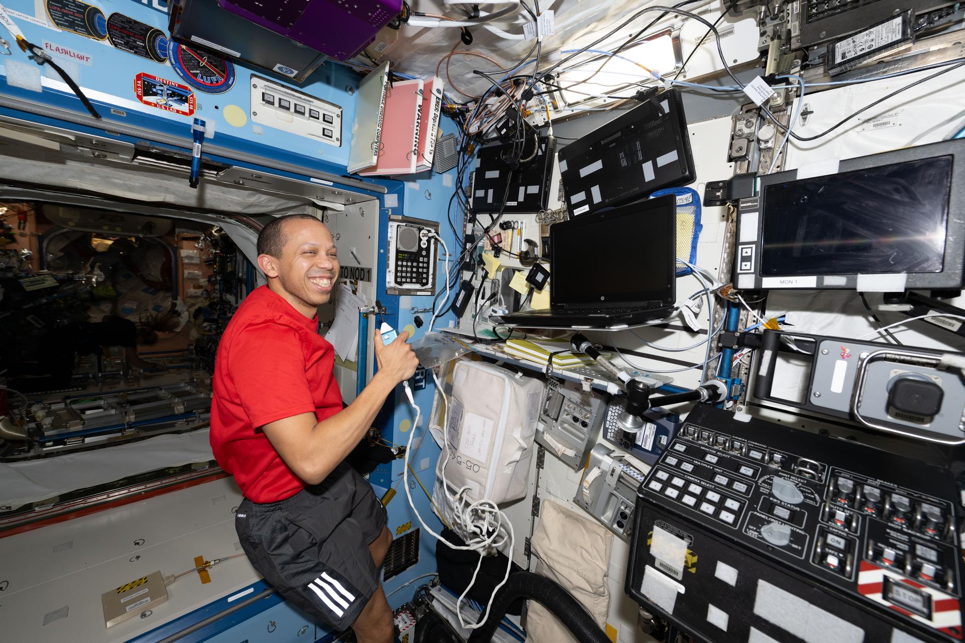 NASA astronaut and Expedition 74 Flight Engineer Chris Williams calls down to mission controllers during Crew Medical Officer training inside the International Space Station’s Destiny laboratory module. Williams trained to use medical hardware, including an automated external defibrillator, and reviewed procedures such as conducting eye exams and administering medicine.