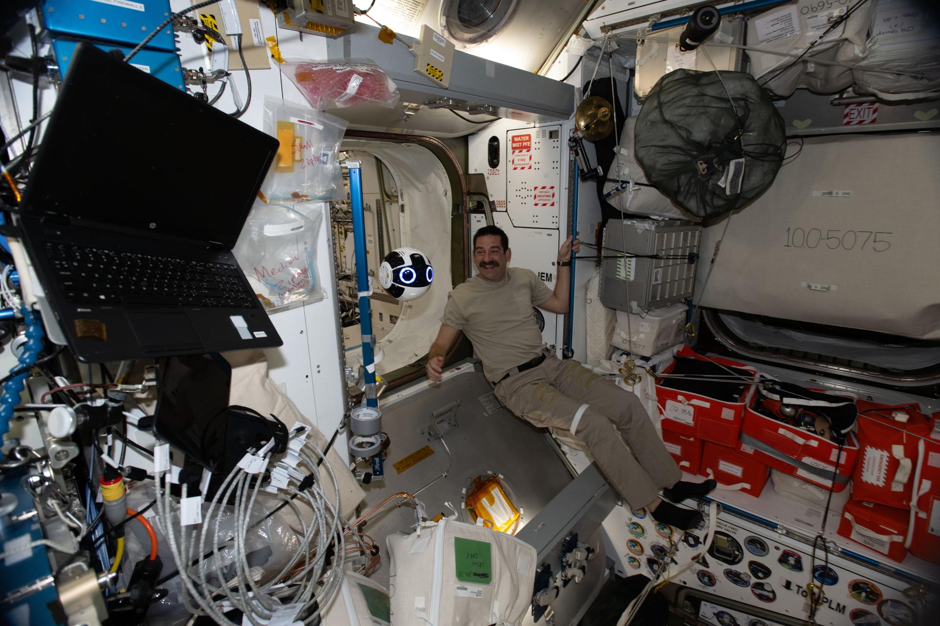 NASA astronaut and Expedition 74 Flight Engineer Jack Hathaway monitors JAXA’s (Japan Aerospace Exploration Agency) Internal Ball Camera 2 inside the International Space Station’s Harmony module. The free‑flying robotic camera, capable of remote flight and automatic docking, is demonstrating the automation of video and photography tasks, allowing the crew more time to conduct microgravity research and other important duties.