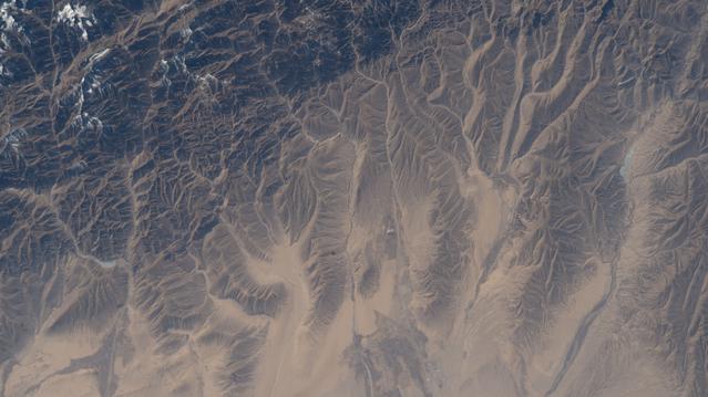 NASA image: The far western edge of the Taklamakan Desert meets the Pamir Mountains in China