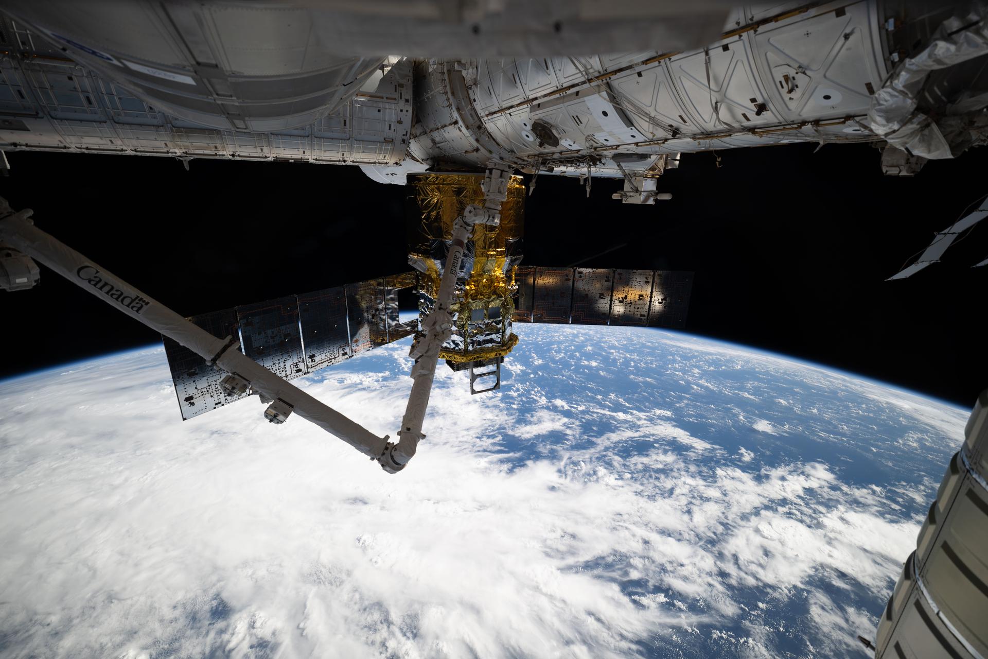 JAXA’s (Japan Aerospace Exploration Agency) HTV-X1 cargo craft, with the Canadarm2 robotic arm perched on a portable data grapple fixture in front, is pictured berthed to the Earth-facing port of the International Space Station’s Harmony module. At the time of this photograph, the orbital outpost was soaring 263 miles above a cloudy Indian Ocean northeast of Madagascar.