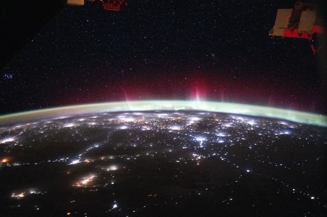 NASA image: An aurora streams above Earth’s atmospheric glow