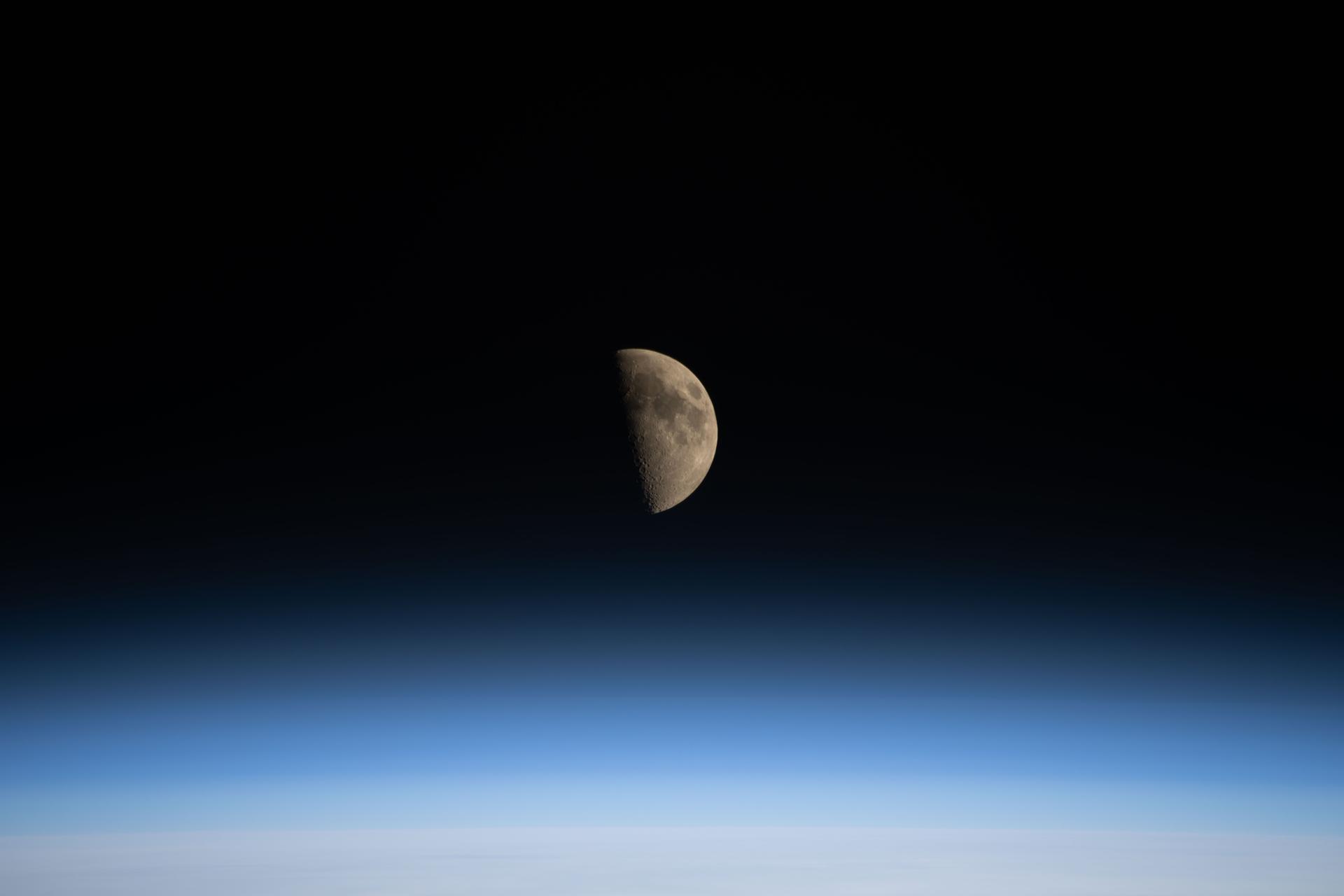 iss074e0325229 (Feb. 24, 2026) --- The first‑quarter Moon is pictured setting over the Pacific Ocean in this photograph from the International Space Station as it orbited 261 miles above Earth. Credit: NASA/Chris Williams