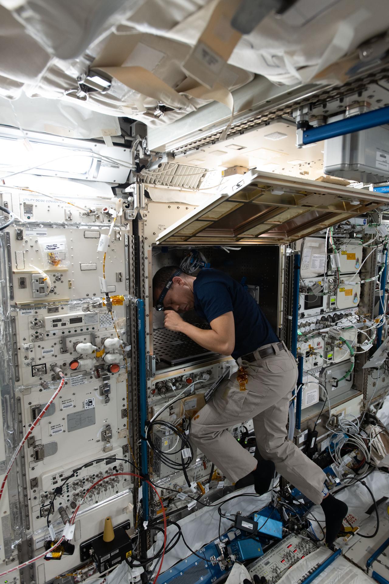 NASA astronaut and Expedition 74 flight engineer Chris Williams works inside the International Space Station's Kibo laboratory module. Williams opened up Kibo's multi-purpose small payload rack to install and configure advanced robotics hardware for the TUSK (Test facility for lab-aUtomation System in Kibo) technology demonstration. TUSK is demonstrating precision mobility and experiment automation in microgravity using a pair of small robotic arms to reduce crew workloads.