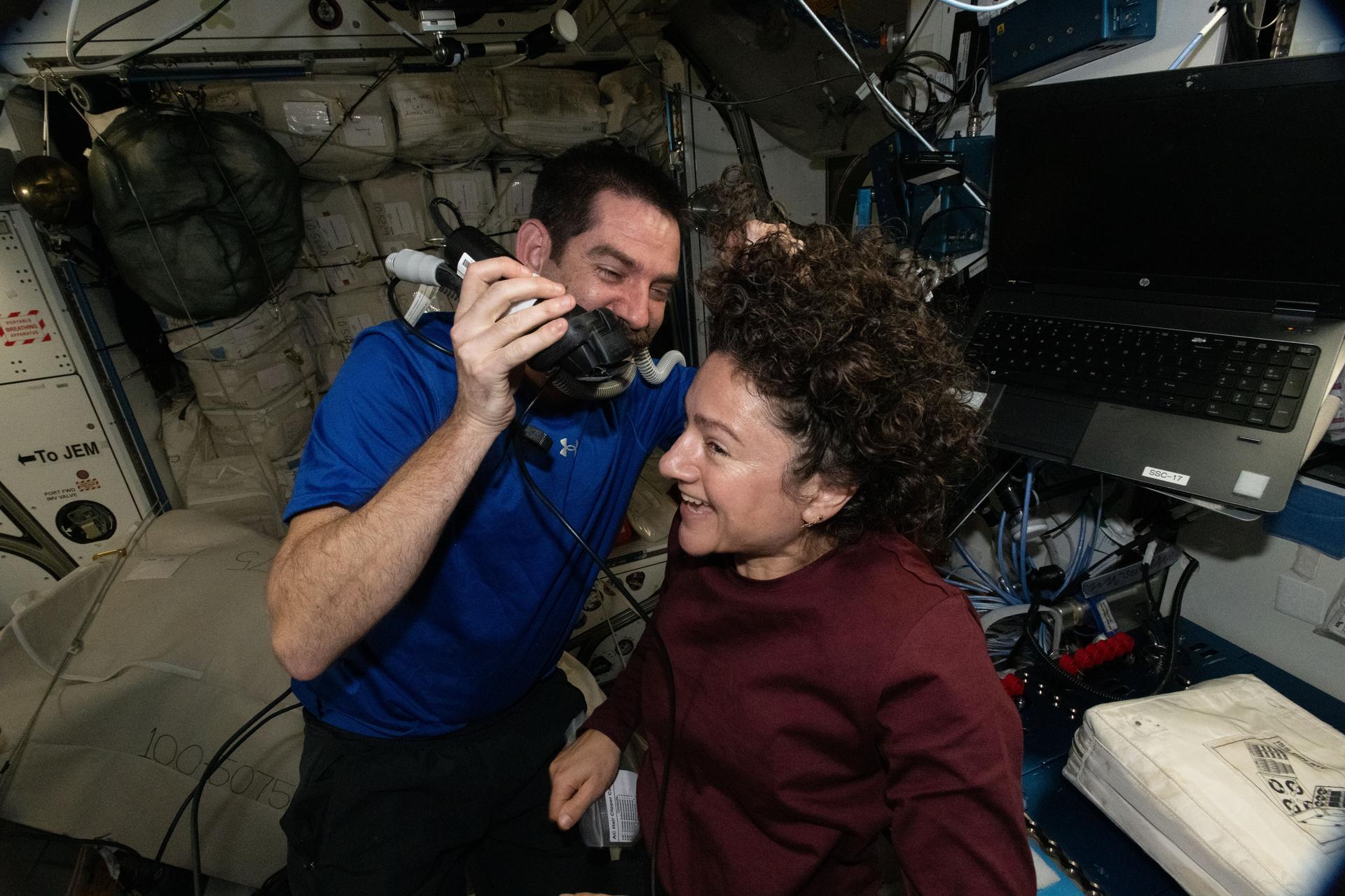 Weekends on the International Space Station are for housecleaning and haircuts. NASA astronaut Jack Hathaway trims the hair of fellow NASA astronaut Jessica Meir, both Expedition 74 flight engineers, using an electric razor attached to a vacuum that collects loose clippings to keep the station’s atmosphere clean in microgravity.
