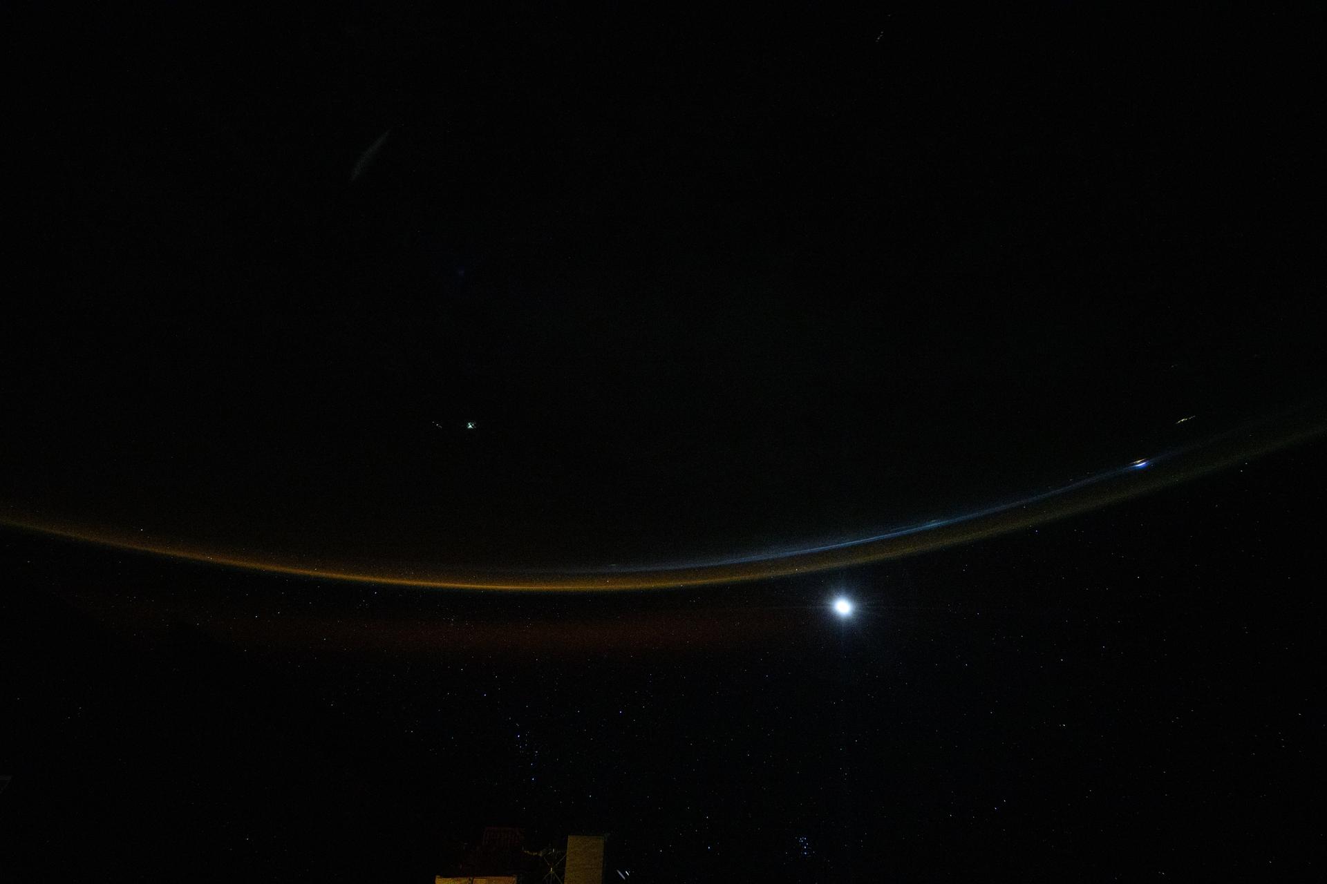 A dim airglow blankets Earth’s horizon as a faint Moon sets above a dark and vast Indian Ocean. The International Space Station was orbiting 265 miles above the Seychelles—an East African archipelago nation of 115 islands—at approximately 11:08 p.m. local time when this photograph was taken.
