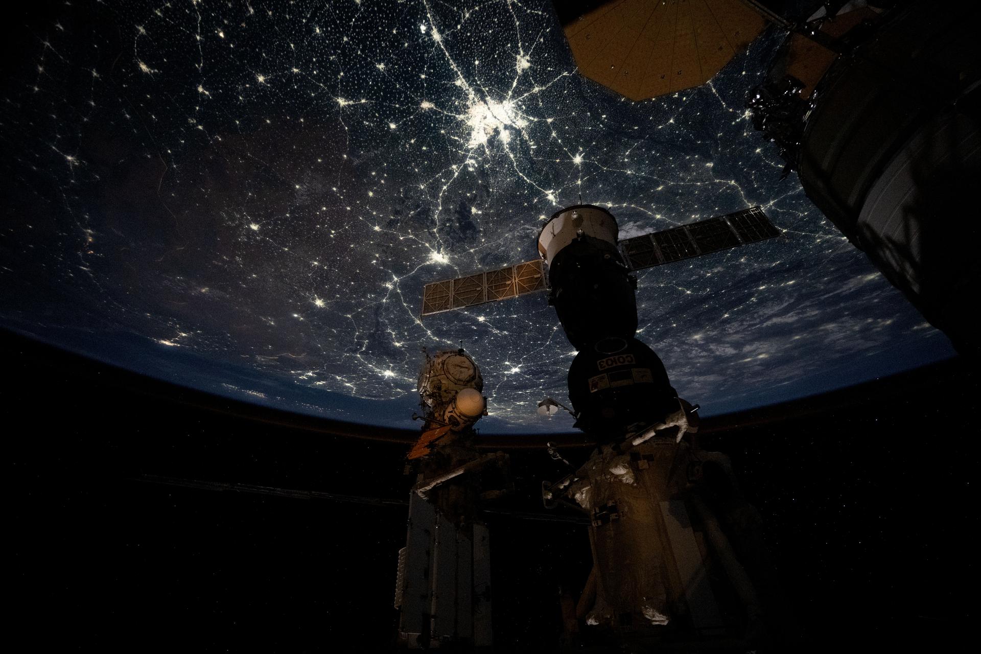 The well‑lit nighttime cityscape of the Indian subcontinent is highlighted by Delhi (center top), the capital territory of India with a metropolitan population of about 33.8 million. The International Space Station was orbiting 264 miles above southwestern China at approximately 11:21 p.m. local time when this photograph was taken.