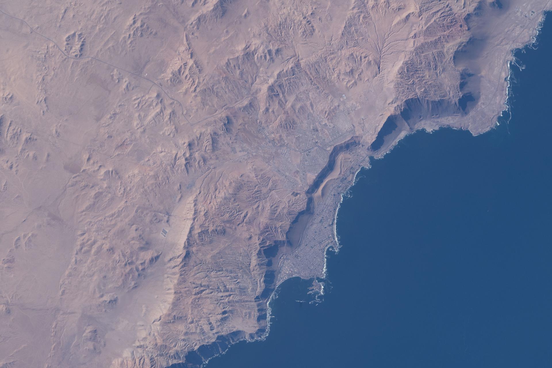 Iquique, Chile, with a population of over 230,000, lies at the base of a steep coastal slope just west of the Atacama Desert—one of the world’s driest regions—on the South American nation’s Pacific coast. The International Space Station was orbiting 264 miles above at the time of this photograph.