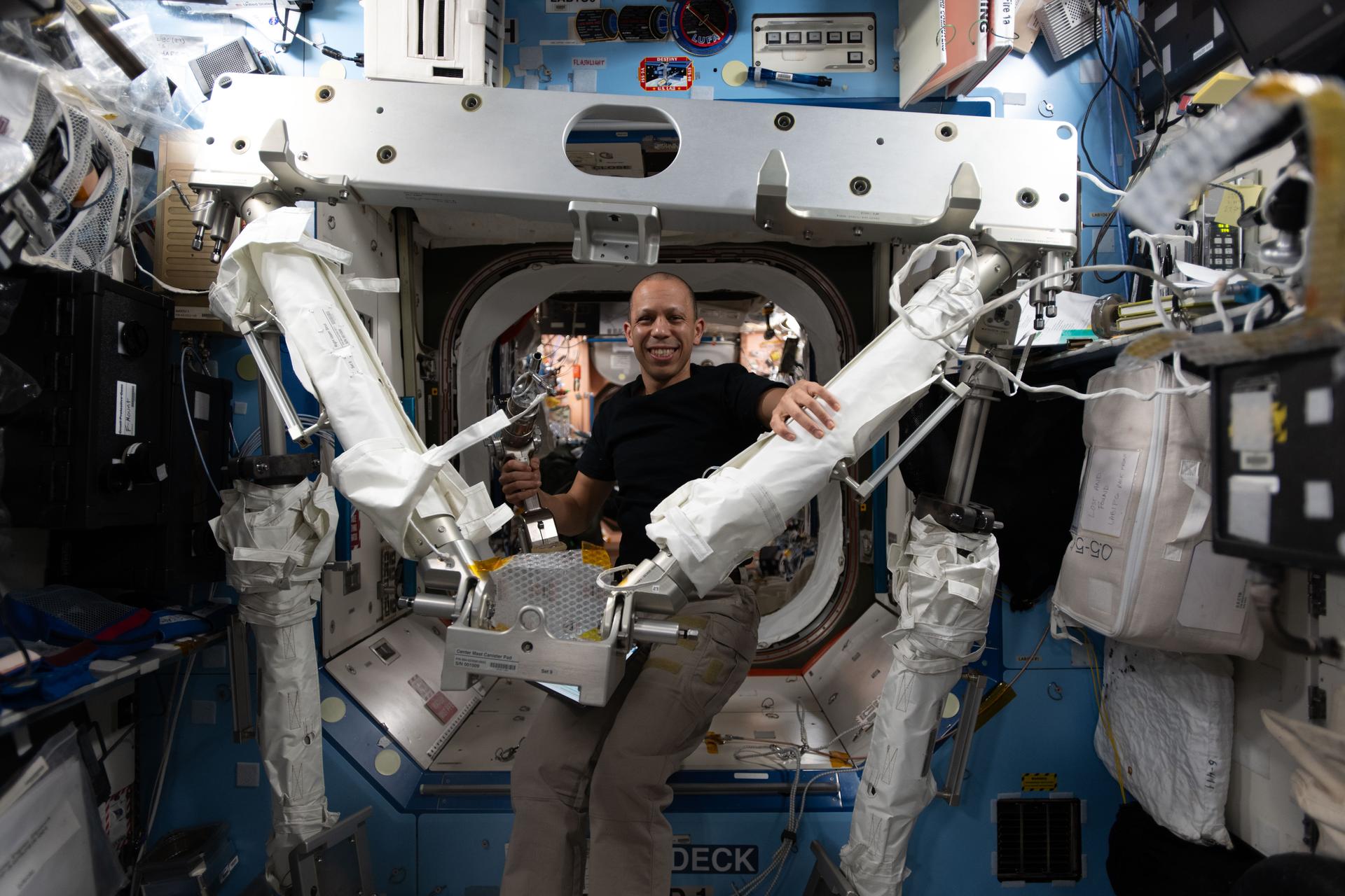 NASA astronaut and Expedition 74 flight engineer Chris Williams familiarizes himself with the hardware he will use to install a modification kit and route cables on the port side of the International Space Station during a spacewalk with fellow NASA astronaut Jessica Meir. The duo will use the hardware to prepare the orbital outpost for a future roll‑out solar array that will be installed during a later spacewalk.