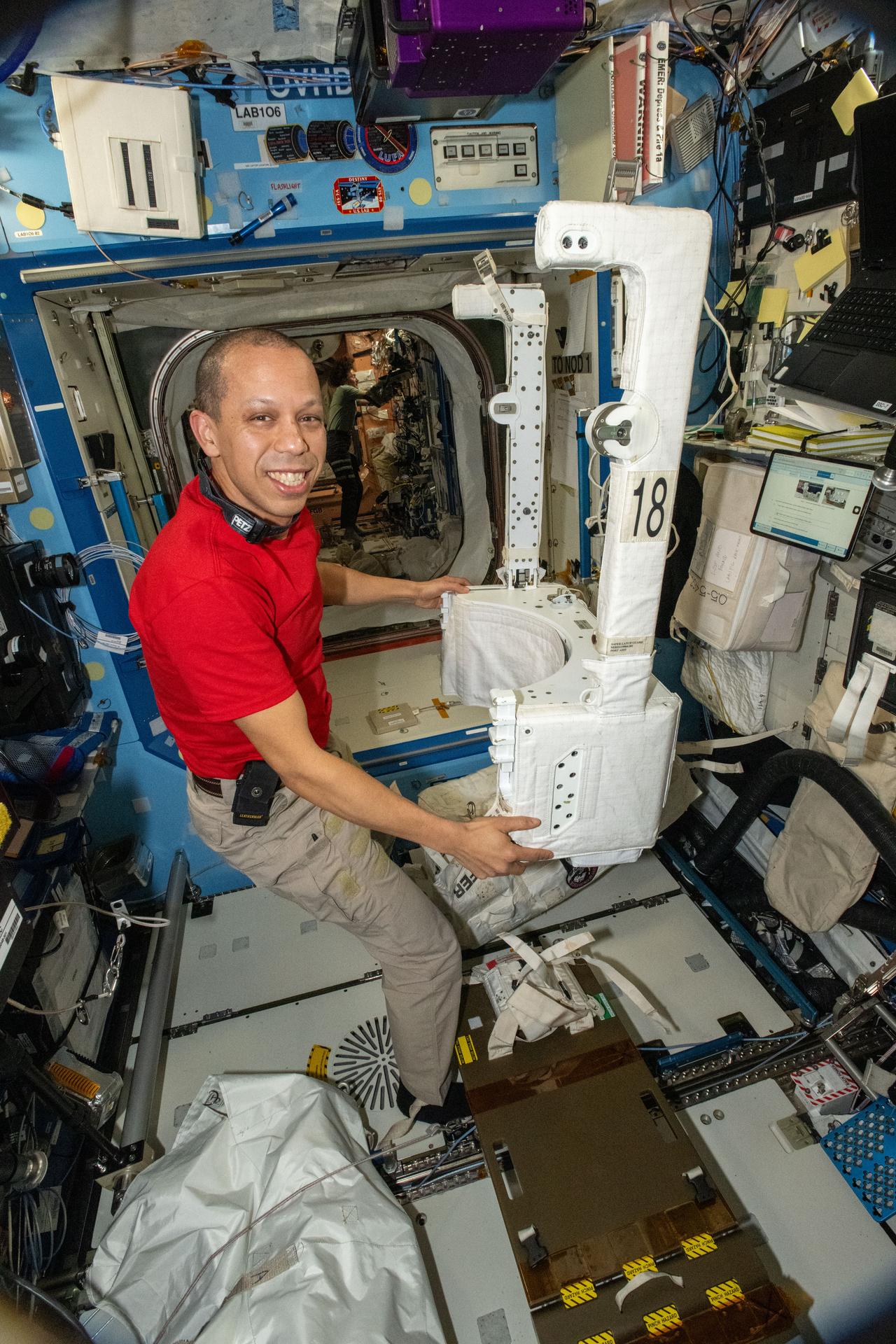 NASA astronaut and Expedition 74 flight engineer Chris Williams inspects and configures a spacesuit jetpack, known as the Simplified Aid for EVA Rescue (SAFER), inside the International Space Station’s Destiny laboratory module. The jetpacks attach to the rear of spacesuits and serve as a safety mechanism that allows a spacewalker to maneuver back to the station in the unlikely event they become untethered from their worksite.