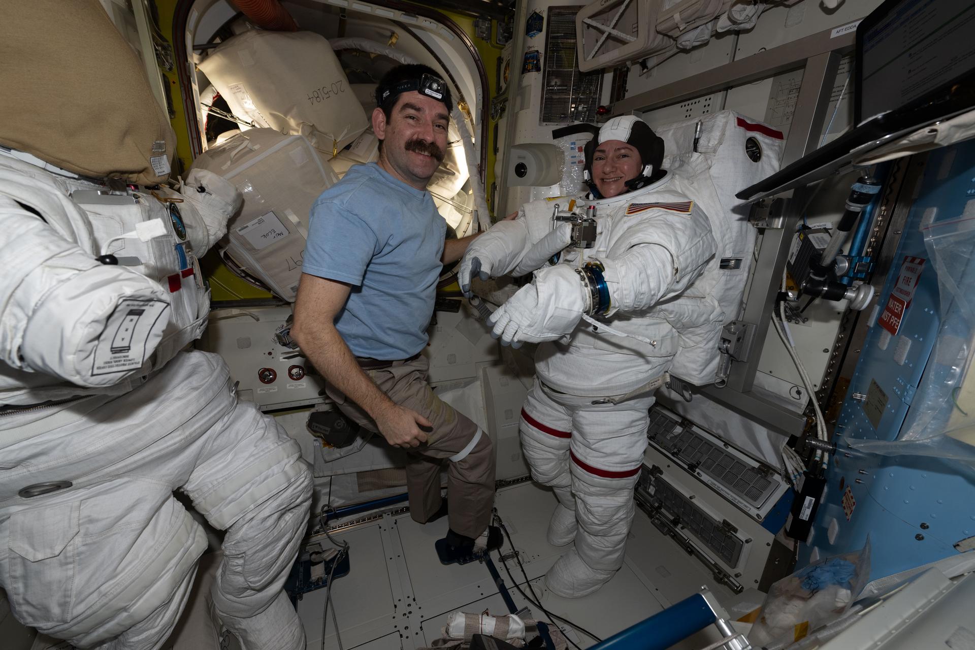 iss074e0375660 (March 10, 2026) --- NASA astronaut Jack Hathaway assists NASA astronaut Jessica Meir, both Expedition 74 flight engineers, as she tries on a spacesuit inside the International Space Station’s Quest airlock. The duo confirmed that the suit was airtight and properly configured, and they assessed its comfort and mobility as microgravity can increase spinal length, redistribute body fluids, and alter the dimensions of the torso and limbs. Credit: NASA/Jessica Meir