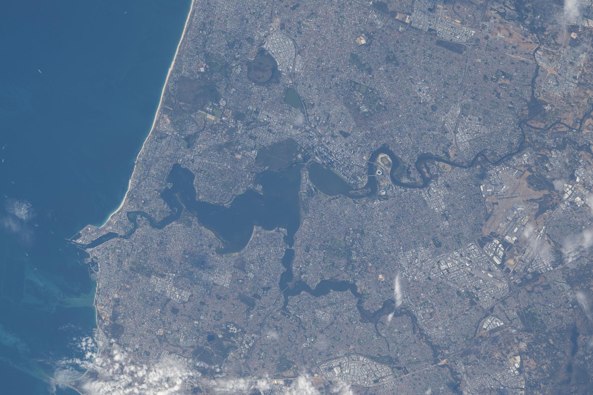 Perth, Australia, located on the nation’s southwestern coast along the Indian Ocean and home to a metropolitan population of nearly 2.5 million, is pictured from the International Space Station as it orbited 269 miles above the province of Western Australia. The Swan River—popular for recreation and home to a diverse array of fish and migratory birds—splits the city and empties into the Indian Ocean.