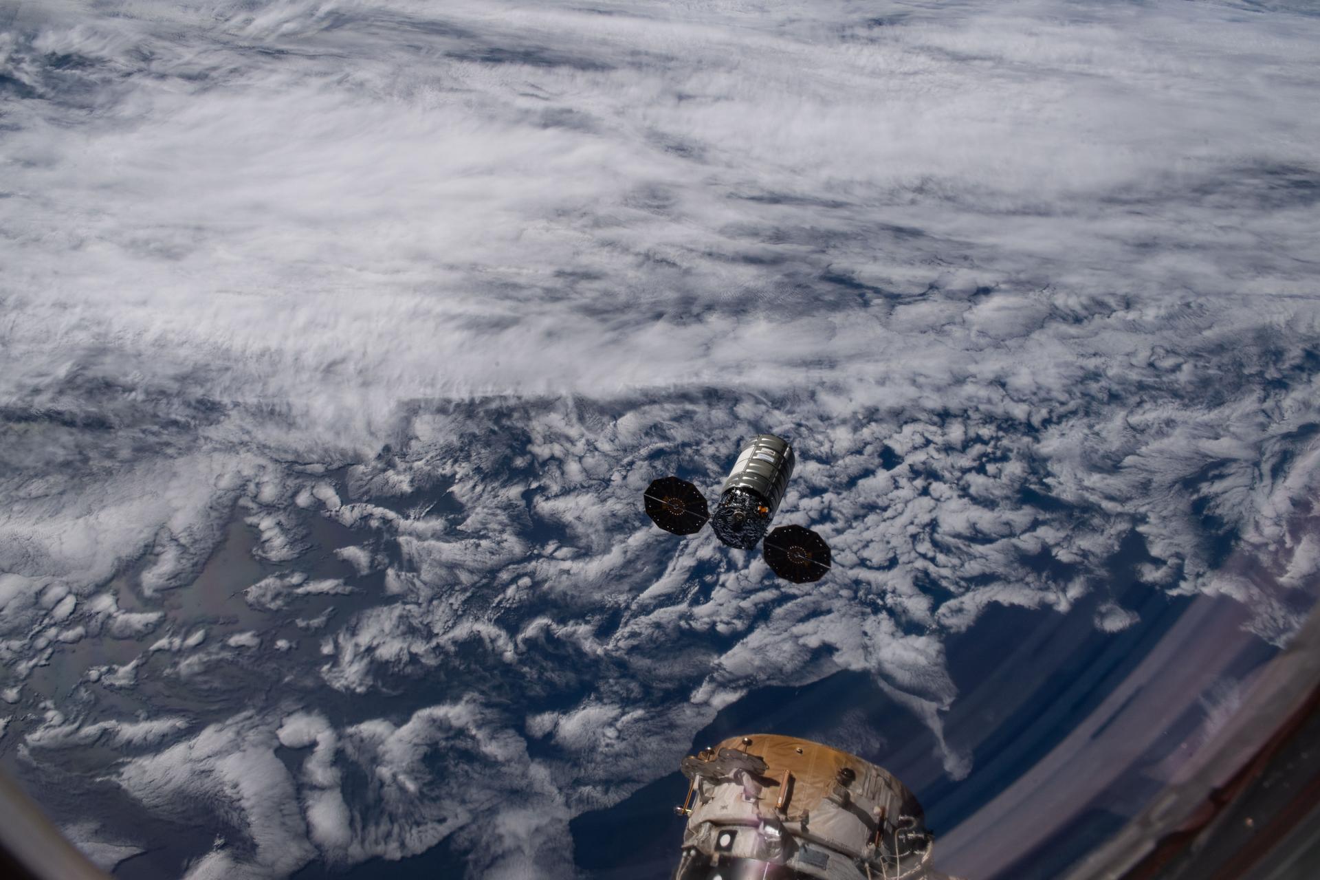 Northrop Grumman's Cygnus XL cargo spacecraft, with its two prominent cymbal-shaped UltraFlex solar arrays, departs the International Space Station moments after being released from the grasp of the Canadarm2 robotic arm completing its resupply mission.