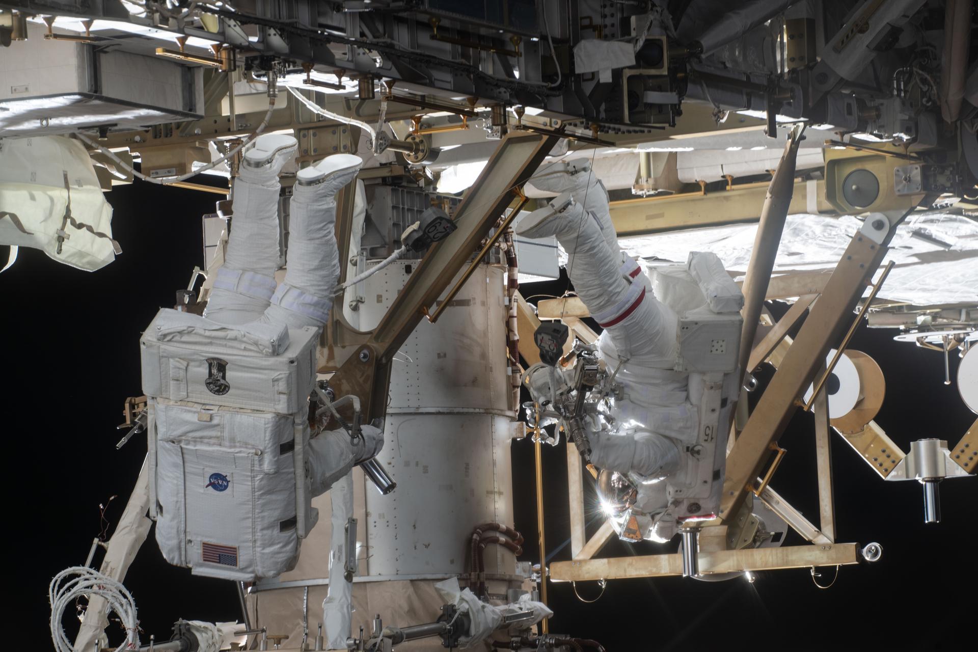 NASA astronauts Chris Williams (left) and Jessica Meir (right) are pictured installing a roll-out solar array modification kit to the International Space Station during a seven-hour, two-minute spacewalk on March 18, 2026.