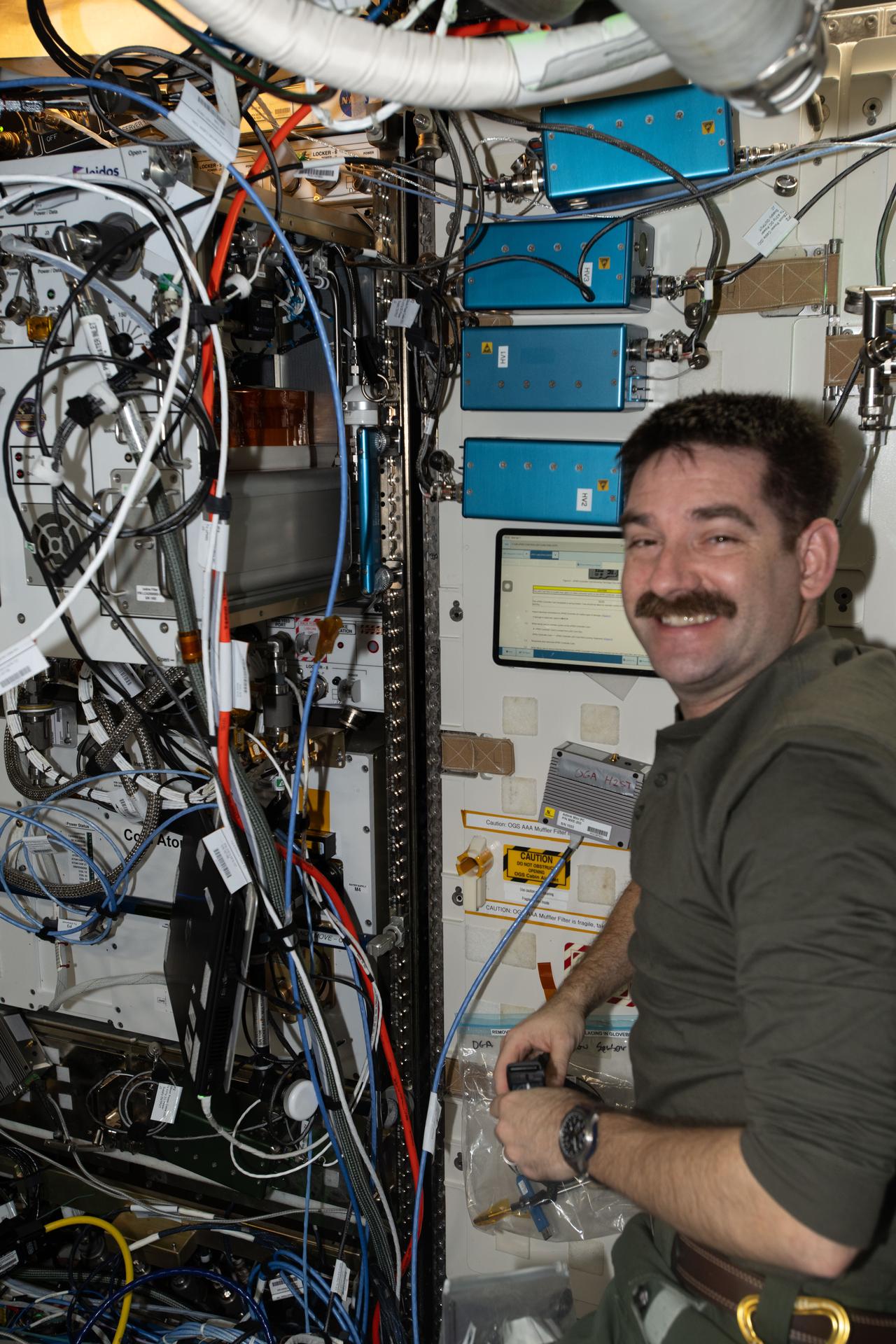 NASA astronaut and Expedition 74 flight engineer Jack Hathaway poses for a portrait inside the International Space Station’s Destiny laboratory module. Hathaway was checking the operation of the Exploration Potable Water Dispenser, a technology demonstration designed to advance water‑sanitization methods, reduce microbial growth, and dispense hot water into crew food and drink bags.