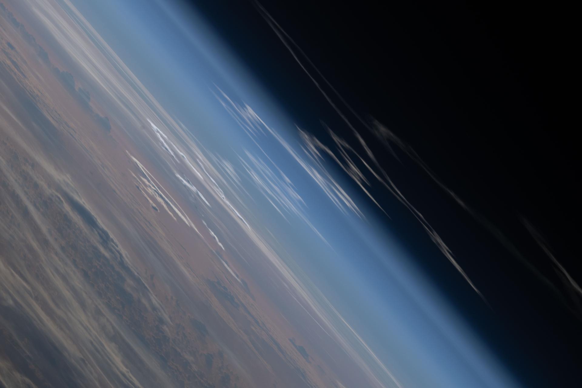 The exhaust plume left behind by the SLS (Space Launch System) rocket that launched Artemis II, NASA’s first crewed mission to the Moon since December 1972, dissipates in the Earth's atmosphere in this photograph from the International Space Station. The orbital outpost was soaring 263 miles above the Atlantic Ocean northwest of Puerto Rico at the time of this photograph.