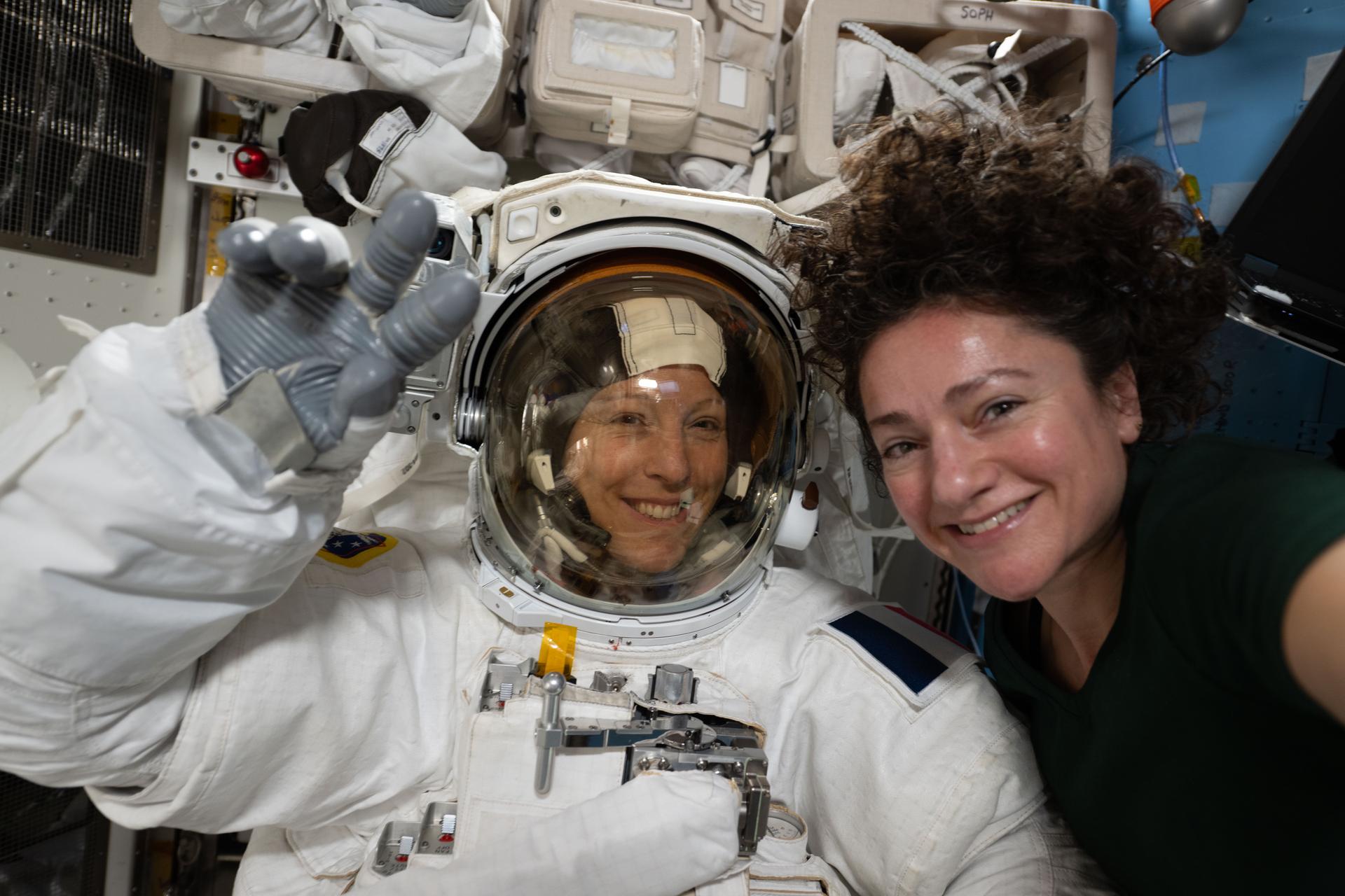 Expedition 74 flight engineers Sophie Adenot of ESA (European Space Agency) and Jessica Meir of NASA pose for a portrait inside the International Space Station’s Quest airlock. Adenot is wearing a spacesuit in a powered and pressurized configuration to test its mobility, comfort, and optimal fit. Meir also assisted Adenot in conducting suit leak and pressure checks while verifying the suit’s communications hardware and life‑support systems.