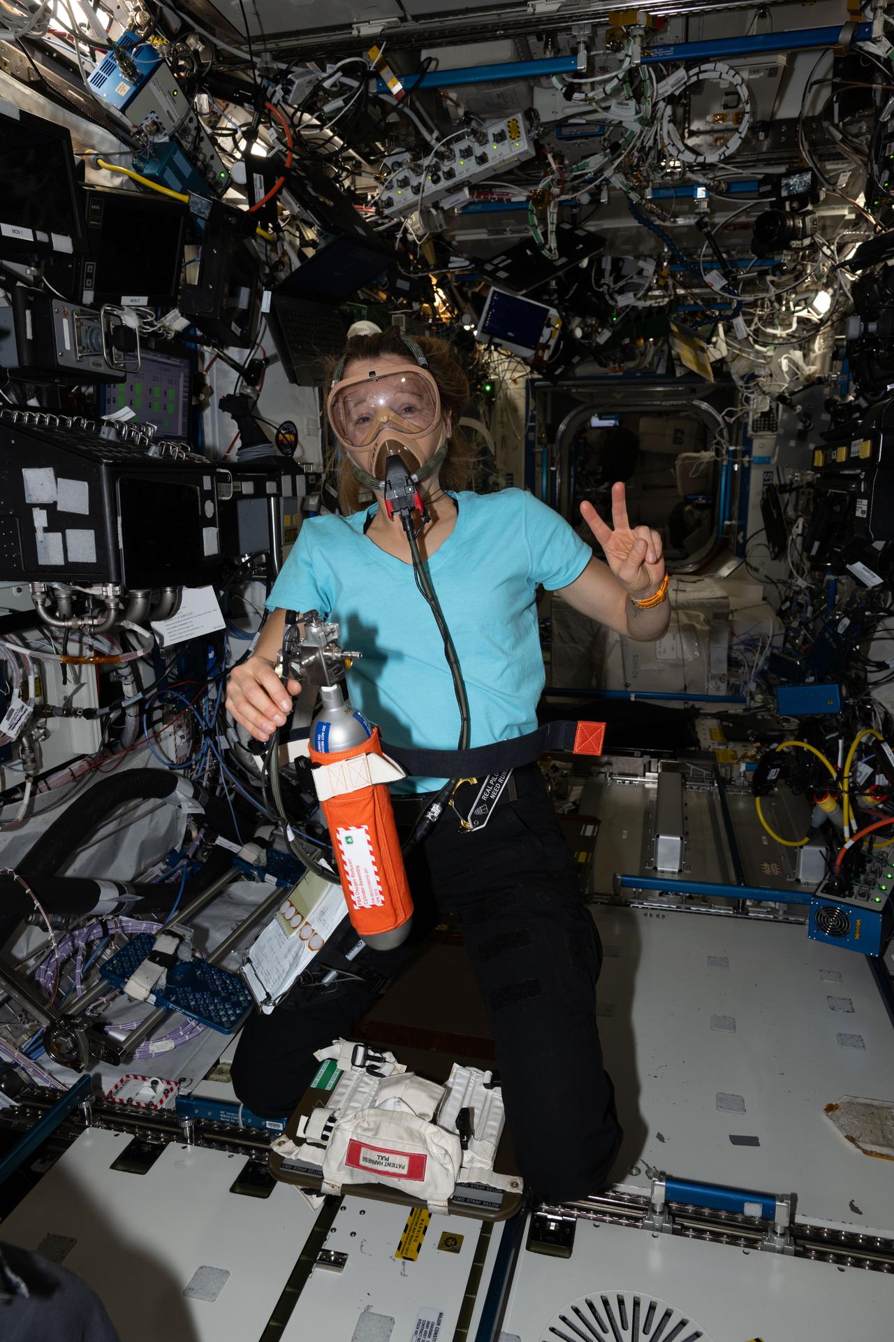 ESA (European Space Agency) astronaut and Expedition 74 flight engineer Sophie Adenot is wearing a portable breathing apparatus to test its readiness for unlikely emergency scenarios such as an oxygen leak, chemical leak, or fire aboard the orbital outpost.