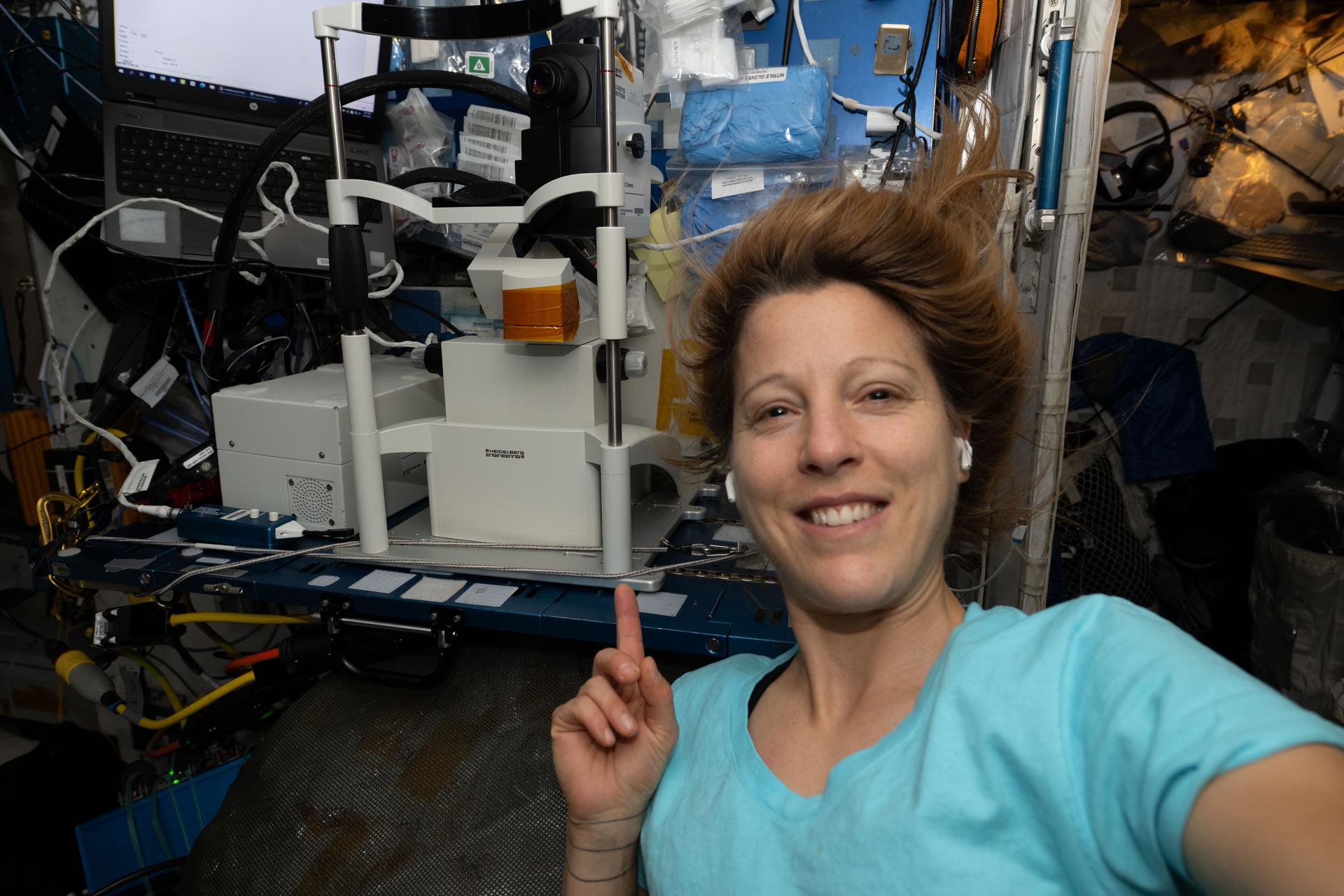 iss074e0433179 (April 3, 2026) --- ESA (European Space Agency) astronaut and Expedition 74 flight engineer Sophie Adenot smiles for a portrait while showing off an Optical Coherence Tomography machine, a medical imaging device used for eye exams. Doctors on the ground monitor the eye exam in real-time viewing an astronaut's retina, lens, and cornea. Vision is critical to a mission’s success and doctors regularly check the astronauts’ eyes to counteract the potential effects of living in space. Credit: ESA/Sophie Adenot