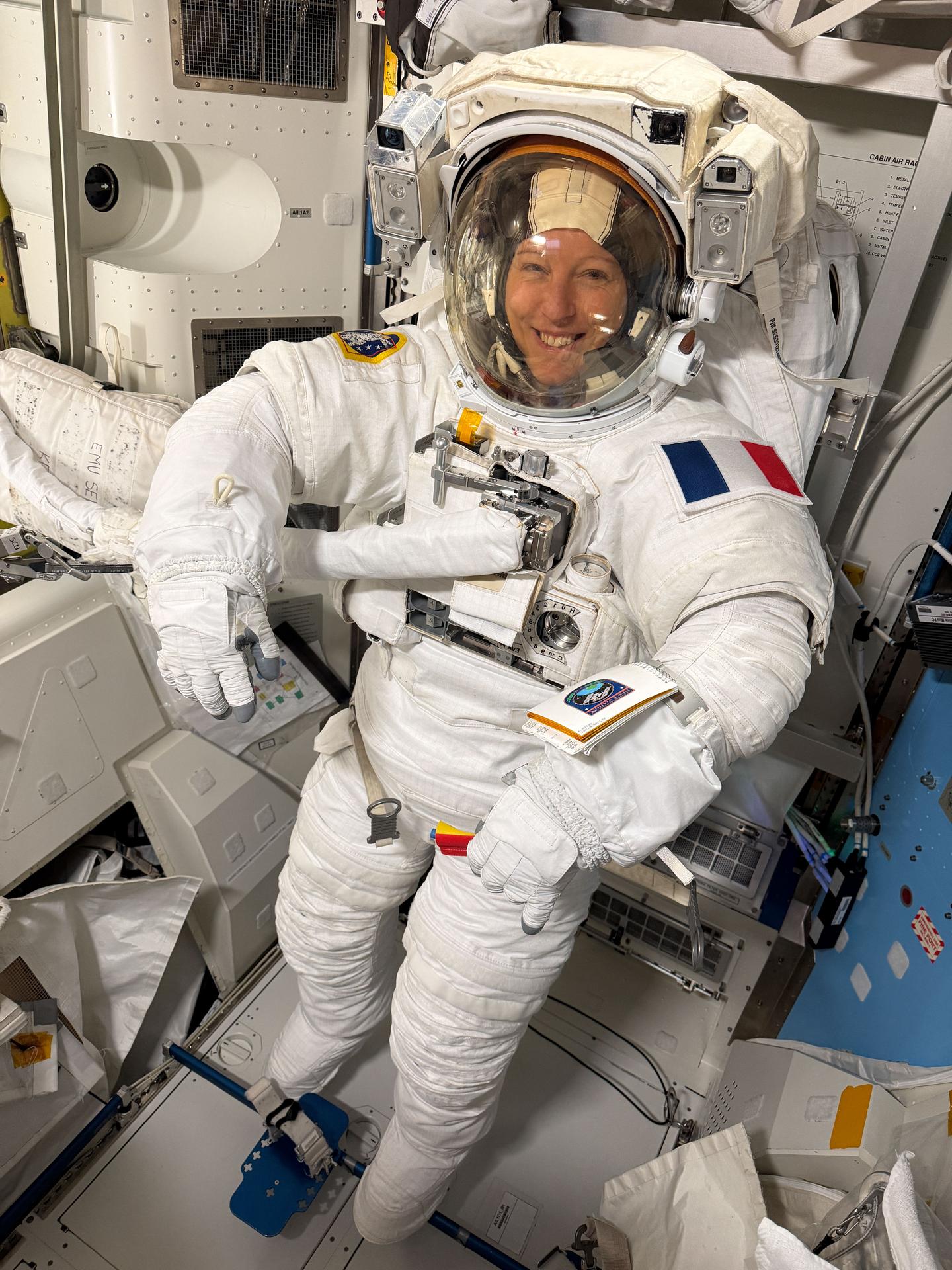 Expedition 74 flight engineer Sophie Adenot of ESA (European Space Agency) wears a spacesuit in a powered and pressurized configuration to verify its comfort, mobility, and functionality inside the International Space Station’s Quest airlock. Adenot also conducted suit leak and pressure checks while verifying the suit’s communications hardware and life-support systems.