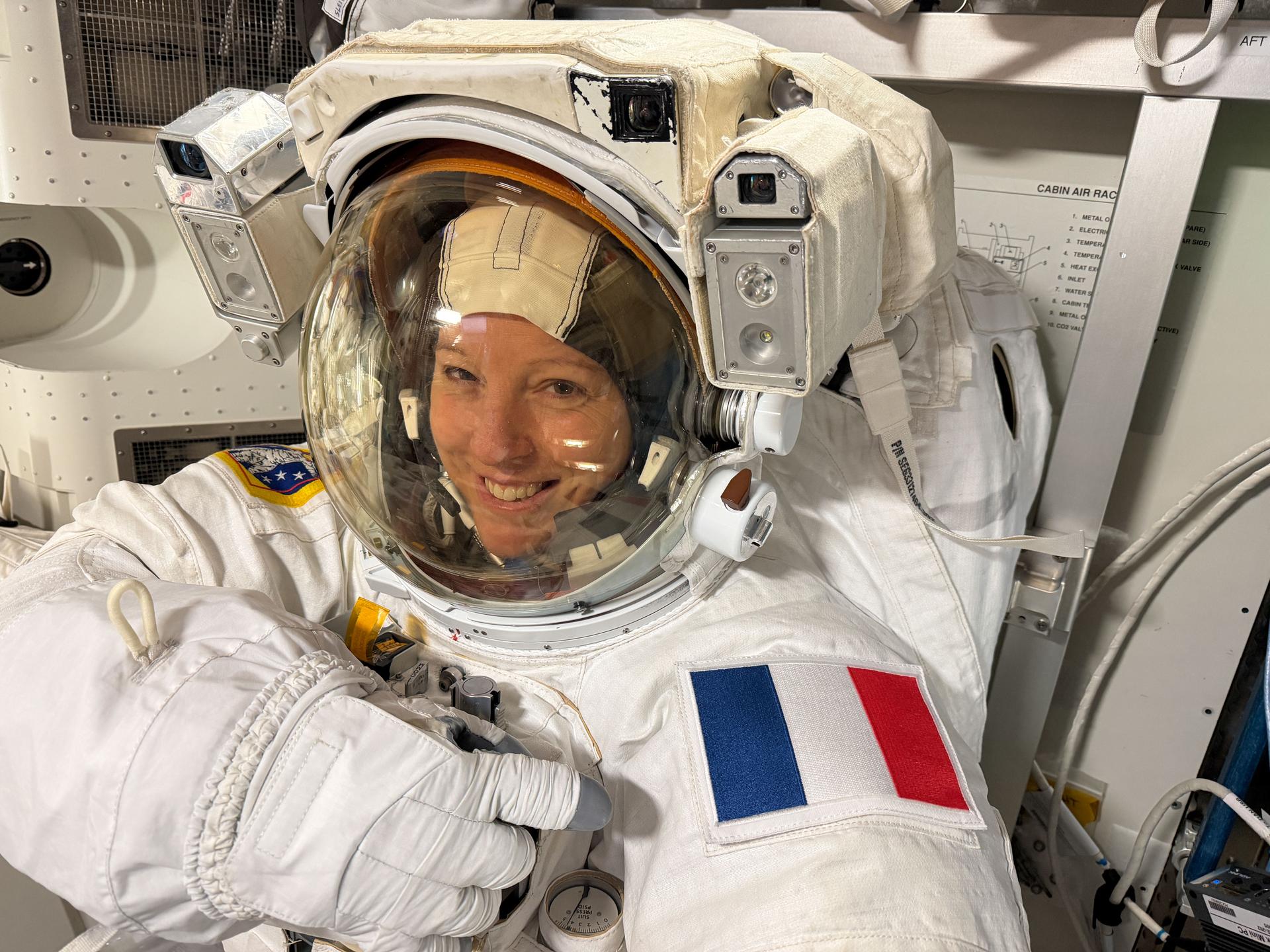 Expedition 74 flight engineer Sophie Adenot of ESA (European Space Agency) wears a spacesuit in a powered and pressurized configuration to verify its comfort, mobility, and functionality inside the International Space Station’s Quest airlock. Adenot also conducted suit leak and pressure checks while verifying the suit’s communications hardware and life-support systems.